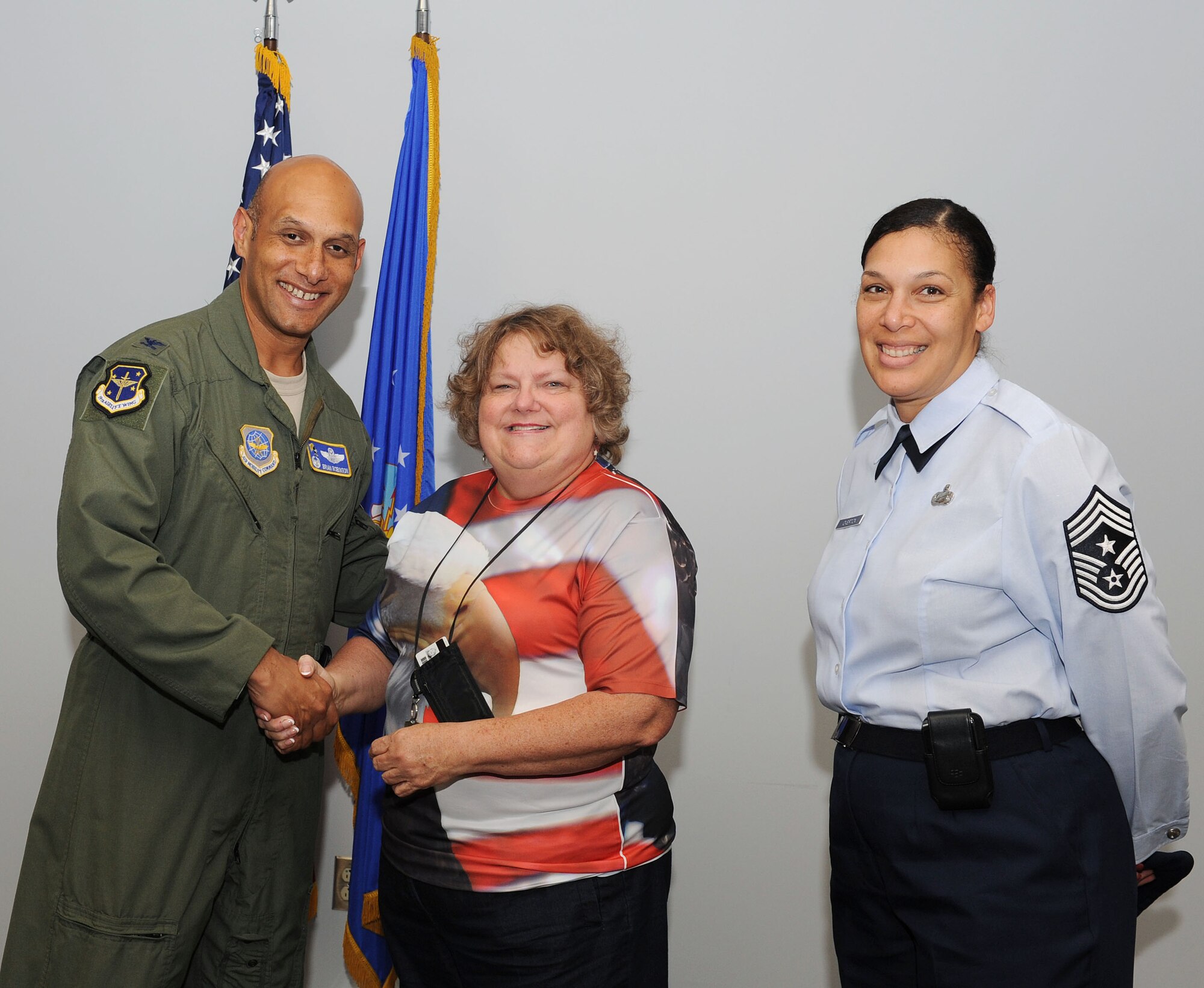 Col. Brian Robinson, 19th Airlift Wing commander and Chief Master Sgt. Margarita Overton, 19th Airlift Wing command chief, congratulates Joan Lindeman, a 19th Medical Group credentials manager, on her selection as Combat Airlifter of the Week July 2, at Little Rock Air Force Base, Ark. Lindeman, a Wichita, Kan., native, has put the Medical Group on the DoD’s highest tier for compliance with her detailed accuracy and dedication.  (U.S. Air Force photo by Airman 1st Class Ellora Remington)