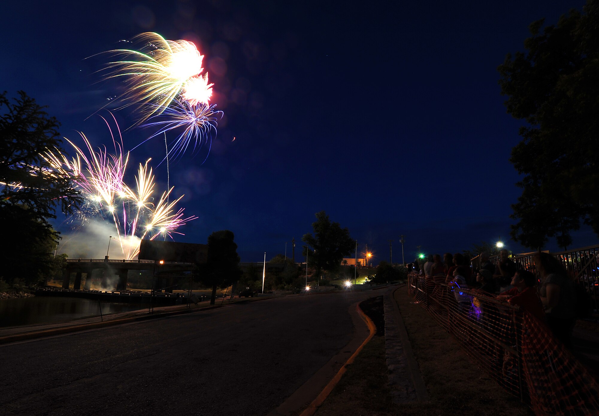SAN ANGELO, Texas-- Fireworks shoot off into the sky as the San Angelo Symphony's July 3rd Pops Concert crowd watches at the Bill Aylor Sr. Memorial River Stage. The event consisted of songs played by the Community Band and San Angelo Symphony, a B-1 Bomber flyover, and a fireworks show. (U.S. Air Force photo/Airman 1st Class Michael Smith)
