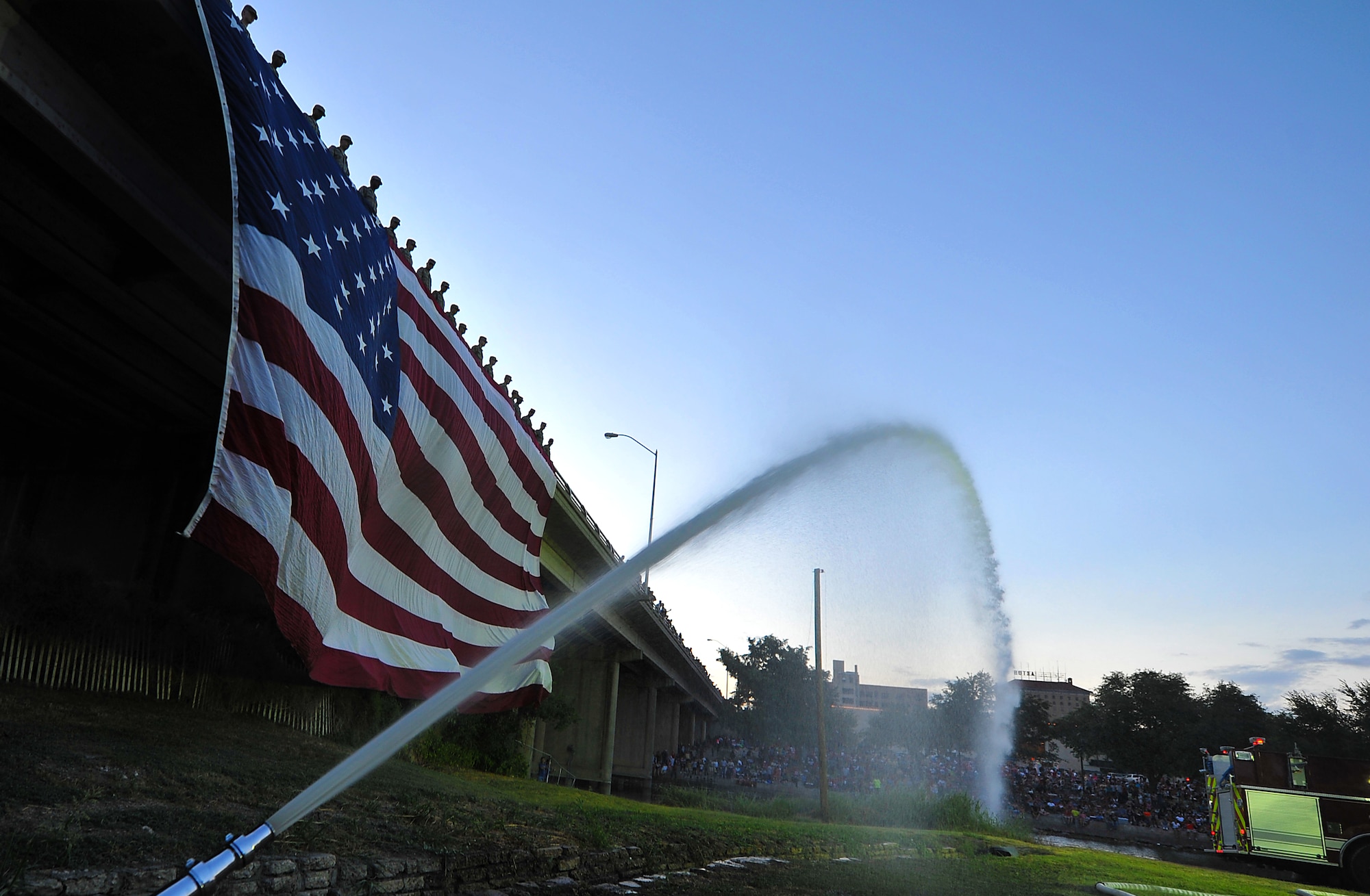 SAN ANGELO, Texas-- Airmen from Goodfellow Air Force Base lower the American Flag during the San Angelo Symphony's July 3rd Pops Concert at the Bill Aylor Sr. Service members from each military branch volunteered to help which contributed to the success of the event. (U.S. Air Force photo/Airman 1st Class Michael Smith)