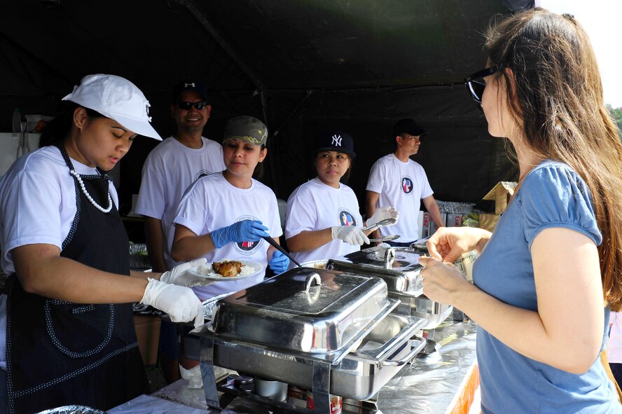 Members of the Filipino-American Association of the Kaiserslautern Military Community serve traditional Filipino food to members of Team Ramstein at the 86th Force Support Squadron’s annual Kaiserslautern Military Community Independence Day celebration, “The Rockin’ 4th,” at the Enlisted Club on Ramstein Air Base, Germany, July 4, 2012. The club helped celebrate July 4th while spreading their mission of charity, culture and unity to members of the Kaiserslautern Military Community. (U.S. Air Force photo/Airman 1st Class Holly Cook)