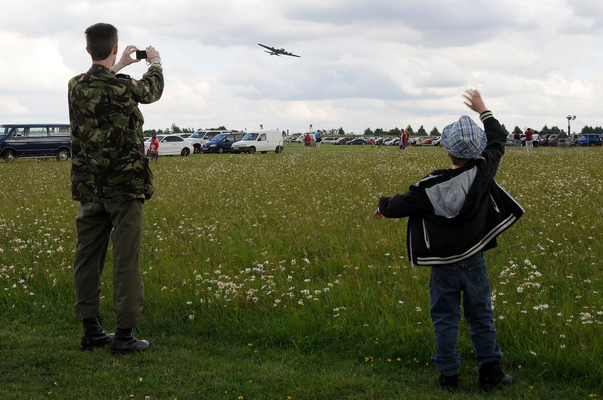 ROYAL AIR FORCE FELTWELL, England - Celebration participants watch Europe's last remaining air-worthy B-17 Flying Fortress, "Sally B," perform an aerial demonstration during the Independence Day celebration here July 4, 2012. Approximately 30,000 Airmen, their families and U.K. residents celebrated the America's Independence Day. The 48th Fighter Wing and 100th Air Refueling Wing hosted the event, which featured aerial demonstrations, games, American food, carnival rides and a fireworks display. (U.S. Air Force by Senior Airman Connor Estes)