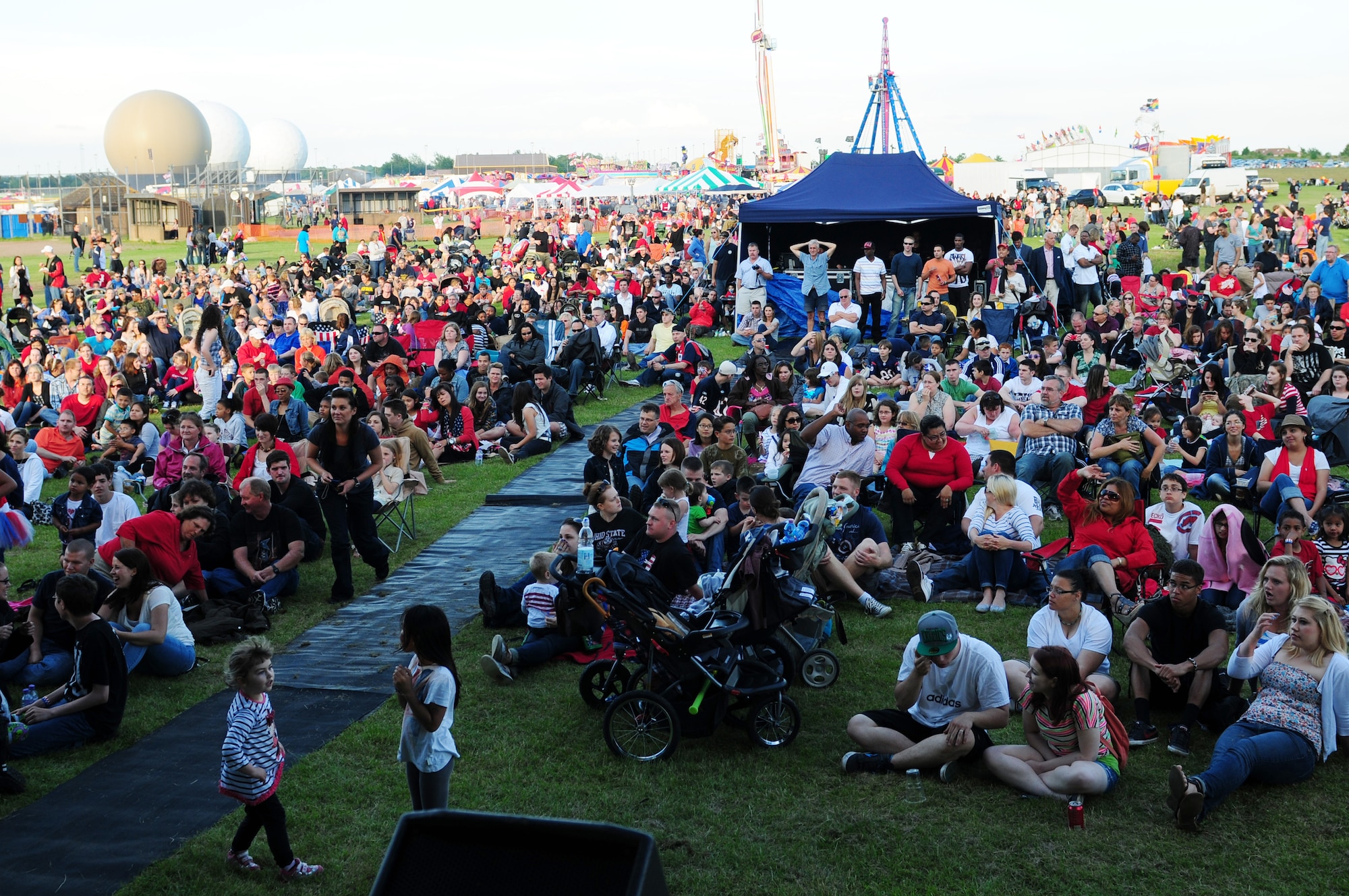 ROYAL AIR FORCE FELTWELL, England - Celebration participants gather to watch an Idols World Tour performance during the Independence Day celebration here July 4, 2012. The Idols World Tour was brought to RAF Feltwell by Armed Forces Entertainment. The 48th Fighter Wing and 100th Air Refueling Wing hosted the celebration, which featured aerial demonstrations, games, American food, carnival rides and a fireworks display. (U.S. Air Force by Senior Airman Lausanne Morgan)