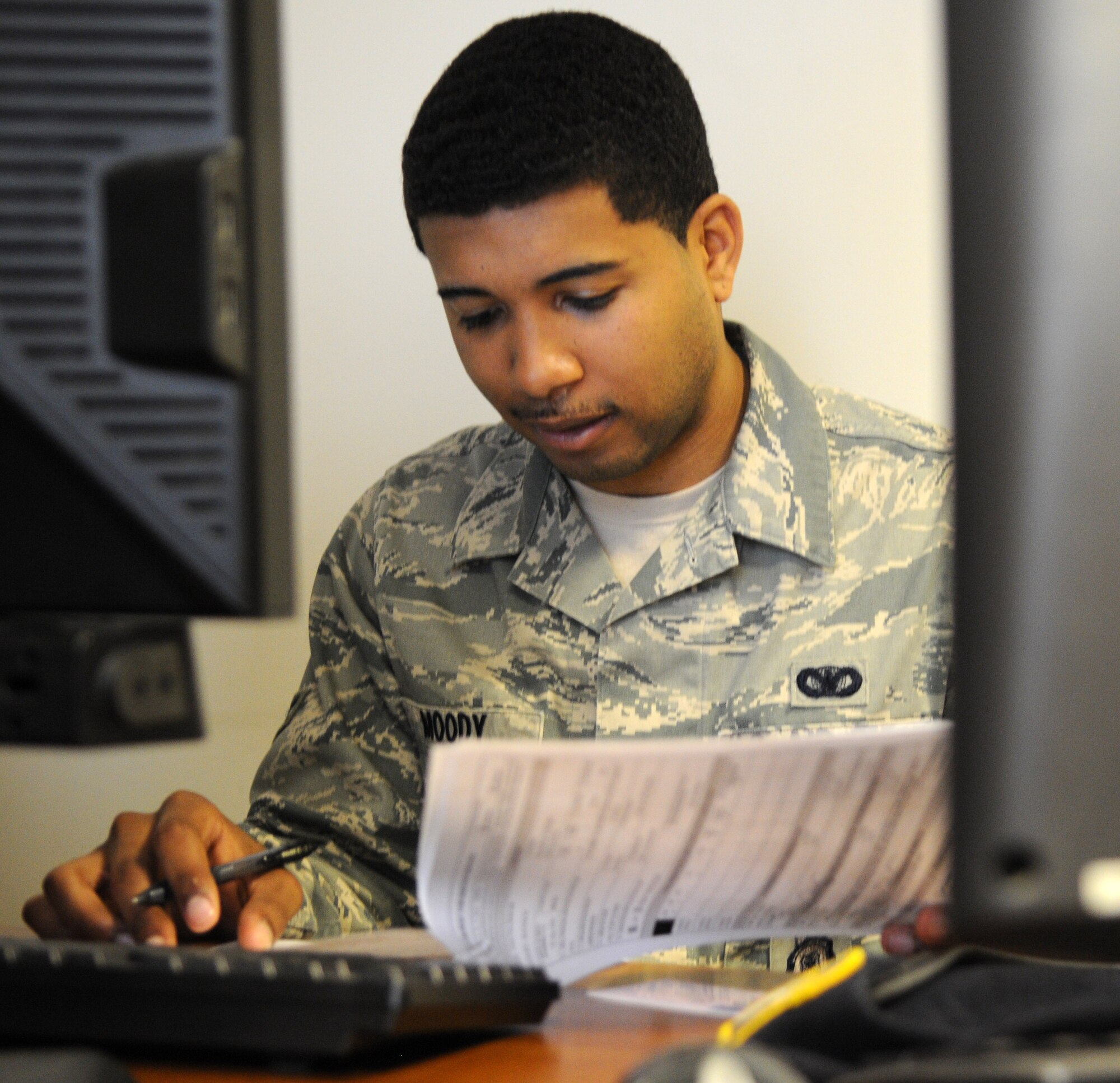 RAF MILDENHALL, England – Airman 1st Class Brandon Moody, 100th Security Forces Squadron, reviews installation access control system paperwork July 6, 2012 at Bldg. 438. The IACS office has relocated from the Bob Hope Community Center to Bldg. 438 next to the pass and registration office.  (U.S. Air Force photo/Senior Airman Rachel Waller) 