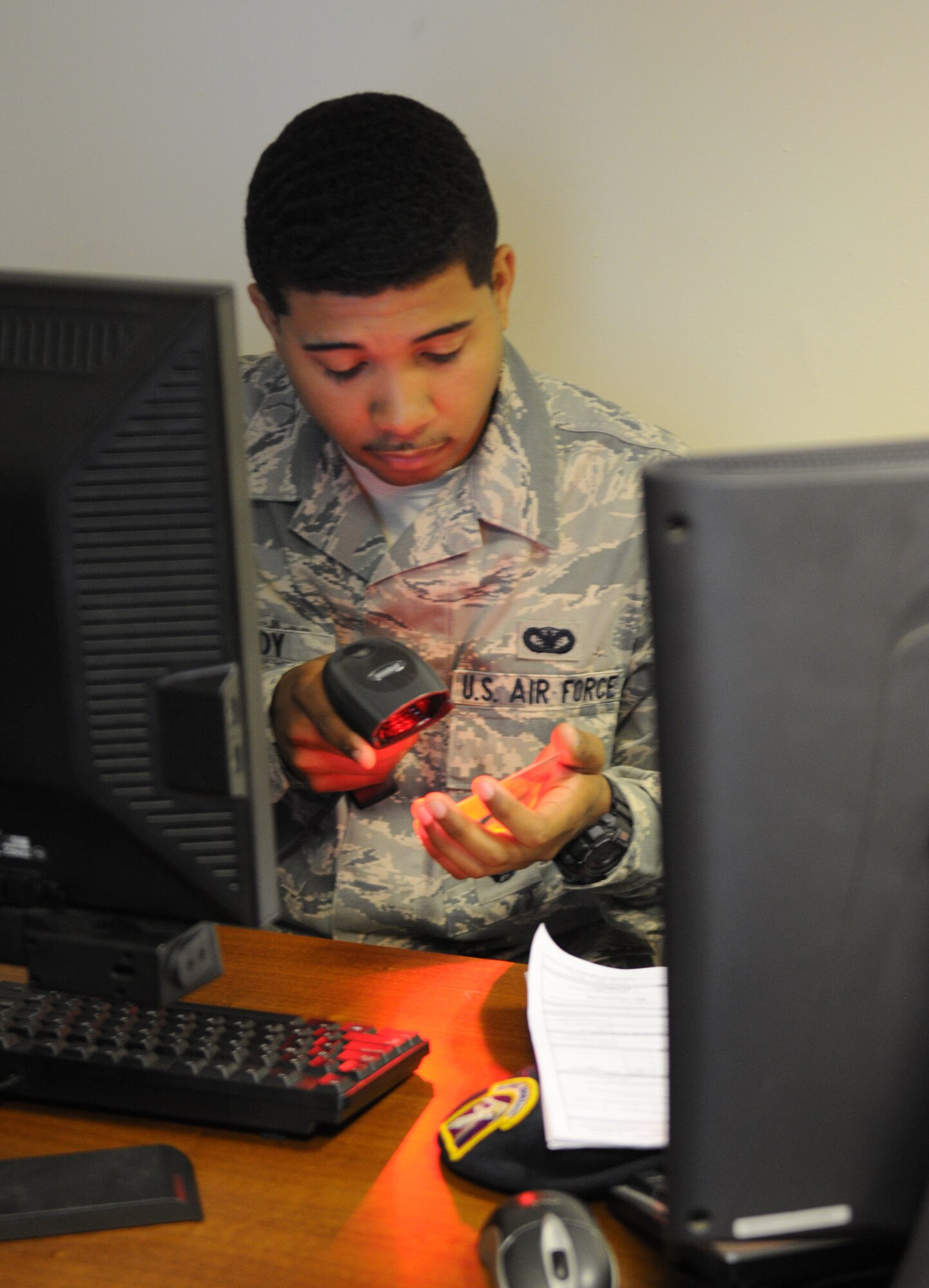 RAF MILDENHALL, England – Airman 1st Class Brandon Moody, 100th Security Forces Squadron, scans a common access card to register it in the installation access control system July 6, 2012 at Bldg. 438. All Team Mildenhall members and their dependents must register their CAC in the IACS before August 1. After this date, members who are not in the system will have to register their CAC at the visitor control center. (U.S. Air Force photo/Senior Airman Rachel Waller) 