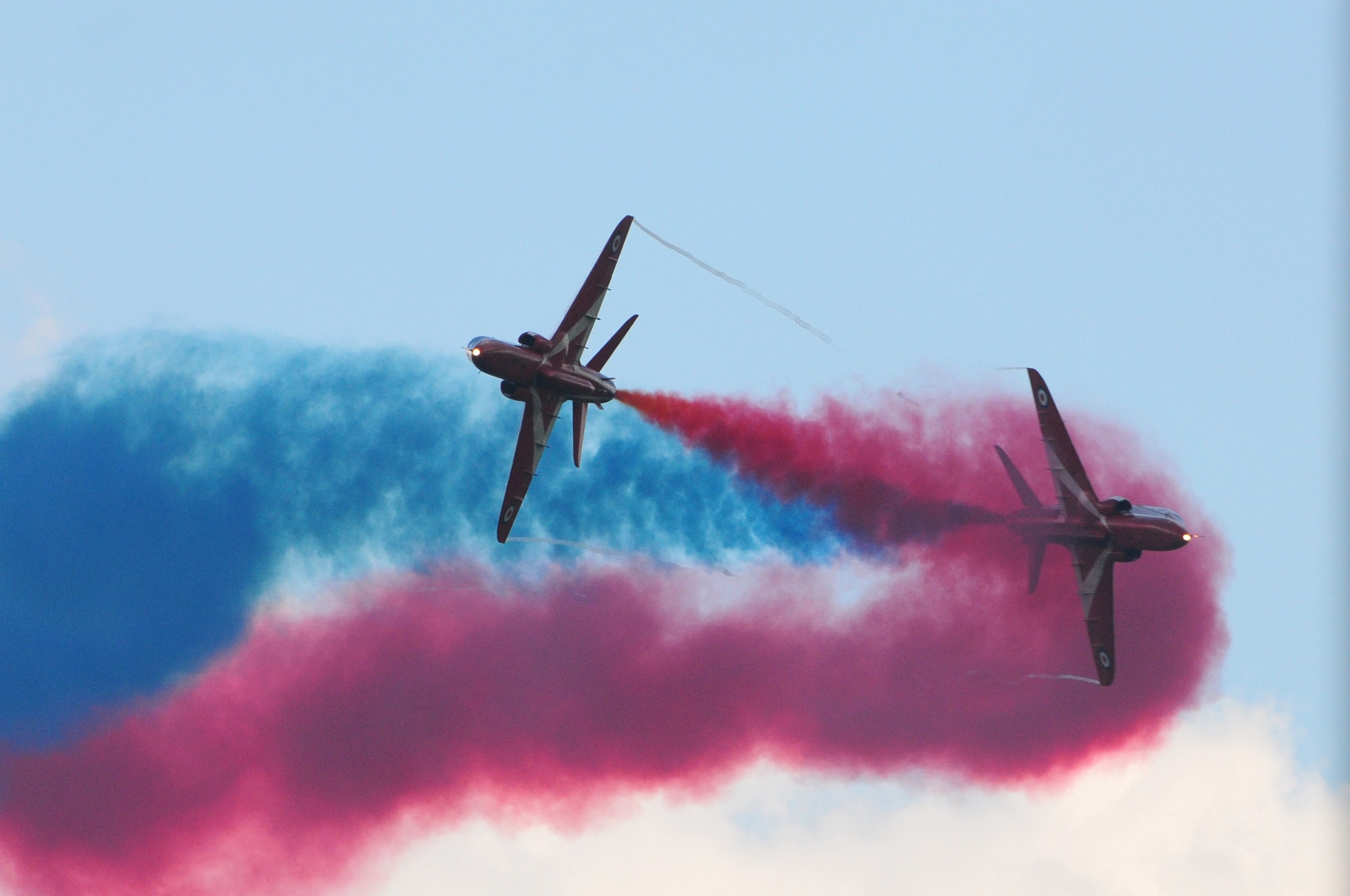 ROYAL AIR FORCE FELTWELL, England - The Royal Air Force Red Arrows Aerobatic Team perform during the Independence Day celebration here July 4, 2012. Approximately 30,000 Airmen, civilians and U.K. residents attended the event. The celebration included carnival games, rides, aerial demonstrations, a birds of prey demonstration and an Idols World Tour performance. (U.S. Air Force by Airman 1st Class Cory D. Payne)