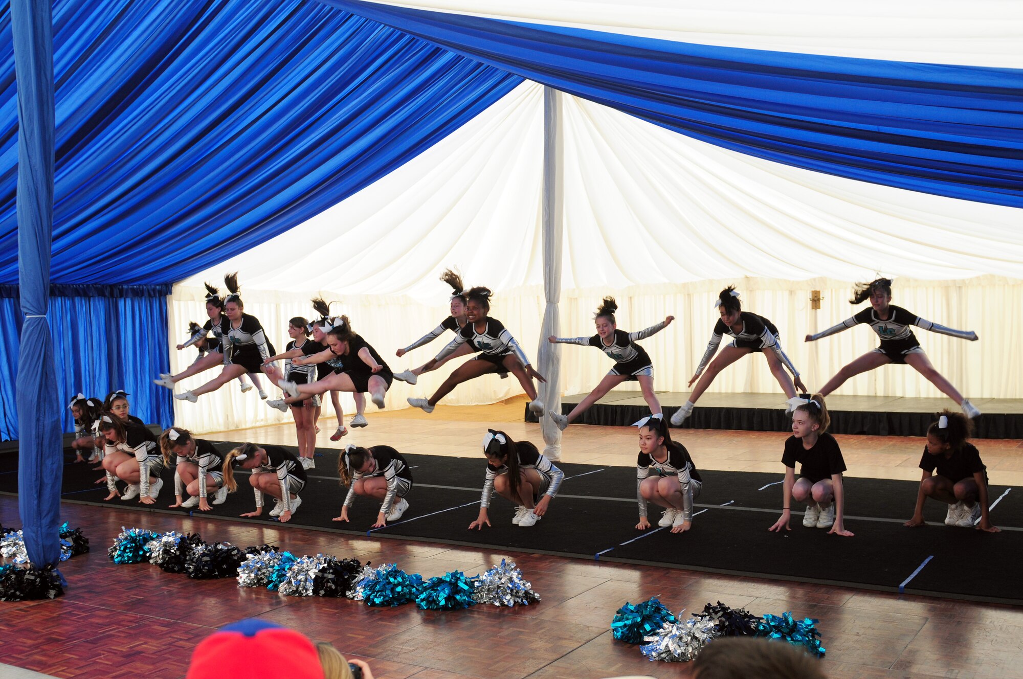 ROYAL AIR FORCE FELTWELL, England – Legacy Cheer Unlimited cheerleaders perform during the Independence Day celebration here July 4, 2012. Approximately 30,000 Airmen, civilians and U.K. residents attended the event. The celebration included carnival games, rides, aerial demonstrations, a birds of prey demonstration and an Idols World Tour performance. (U.S. Air Force by Airman 1st Class Cory D. Payne)