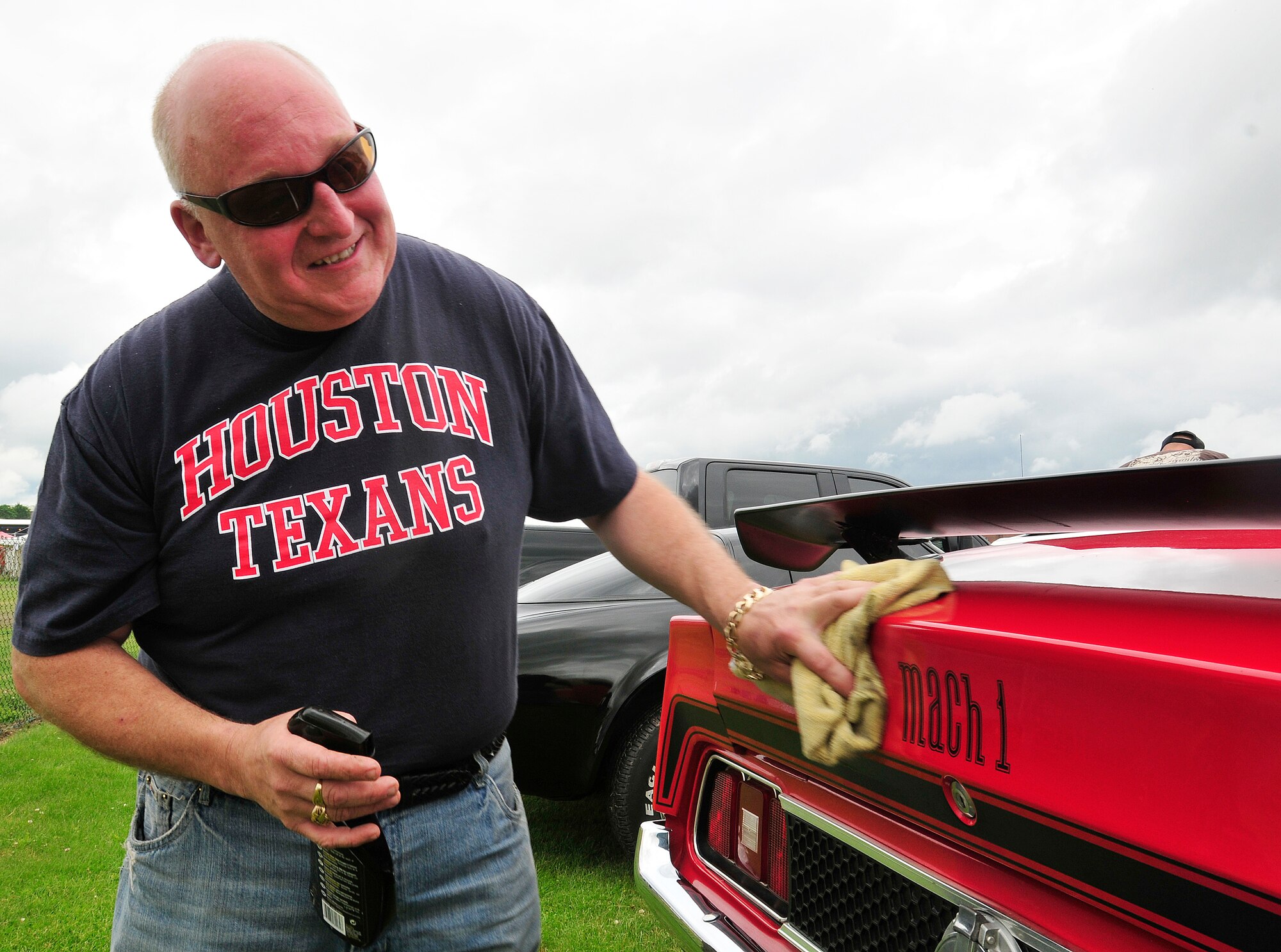 ROYAL AIR FORCE FELTWELL, England – Adrian Waller, restaurant owner, wipes down his 721 Mach 1 Ford Mustang at the car and bike show, an event held during the Independence Day celebration here July 4, 2012. Approximately 30,000 Airmen, civilians and U.K. residents attended the event. The celebration included carnival games, rides, aerial demonstrations, a birds of prey demonstration and an Idols World Tour performance. (U.S. Air Force by Senior Airman Tiffany M. Deuel)