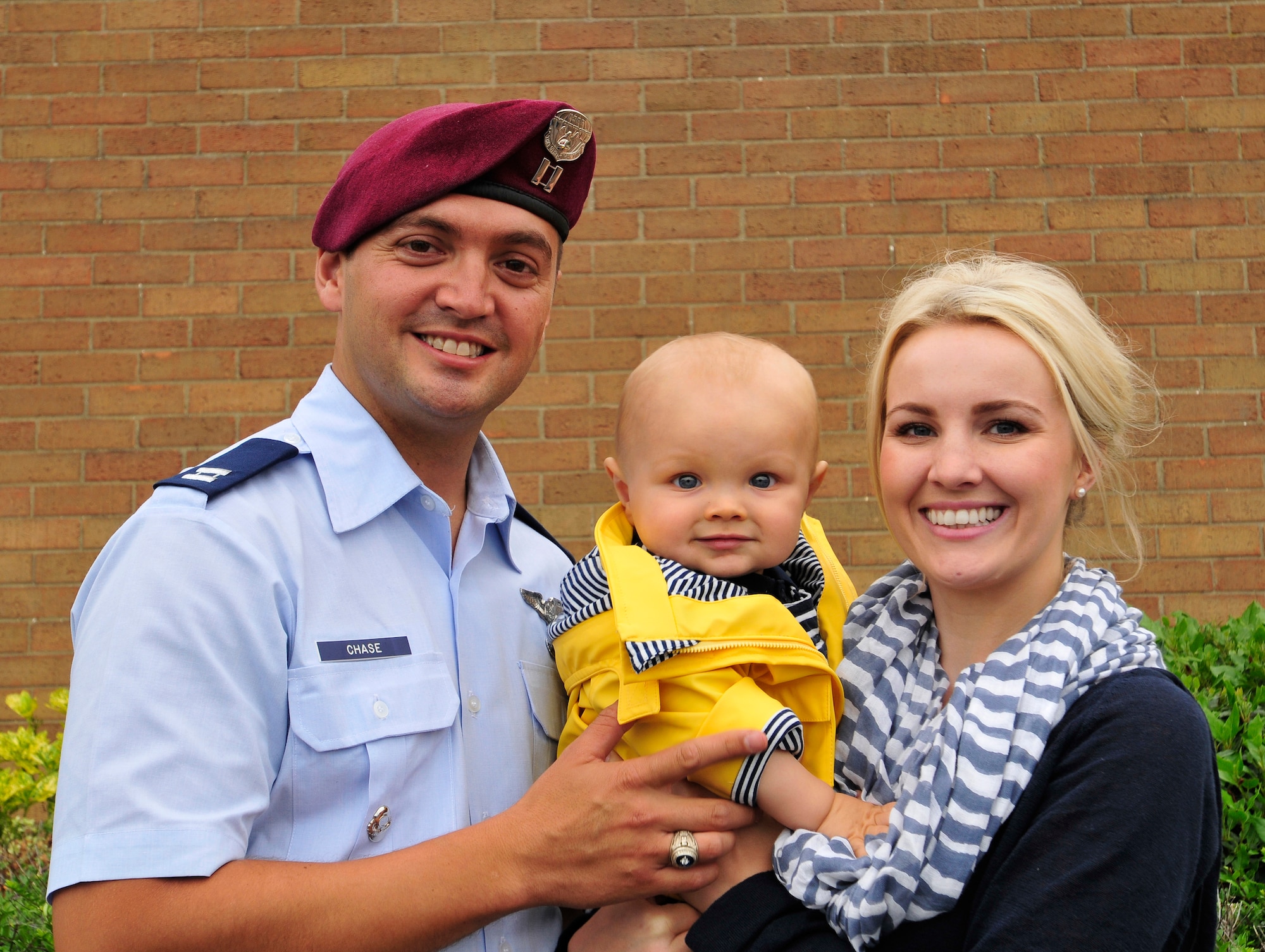 ROYAL AIR FORCE LAKENHEATH, England - Capt. William Chase, 56th Rescue Squadron flight commander, poses with his 8-month-old son Ethan and wife Carmel July 2, 2012. Chase recently assisted in the care of an elderly British man on a flight from London to Los Angeles, avoiding the need for an emergency landing.  (U.S. Air Force photo by Senior Airman Tiffany M. Deuel)
