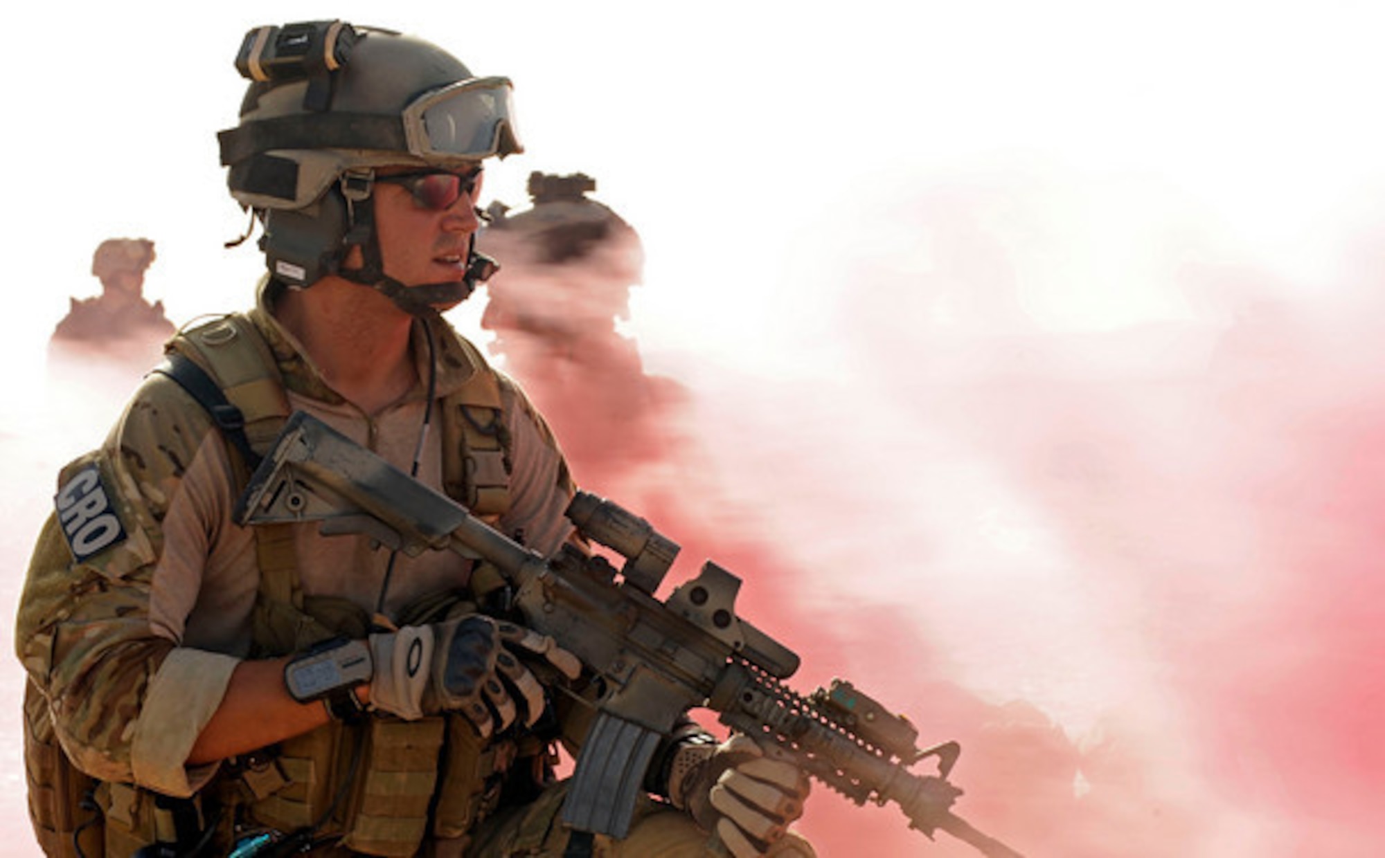 CAMP LEMONIER, Djibouti - Capt. William Chase, 56th Rescue Squadron flight commander and combat rescue officer attached to the 82nd Expeditionary Rescue Squadron, looks out as red smoke from a smoke grenade engulfs his position during a joint mass casualty exercise May 20, 2009. Chase recently assisted in the care of an elderly British man on a flight from London to Los Angeles, avoiding the need for an emergency landing. (U.S. Air Force photo by Staff Sgt. Joseph L. Swafford Jr.)