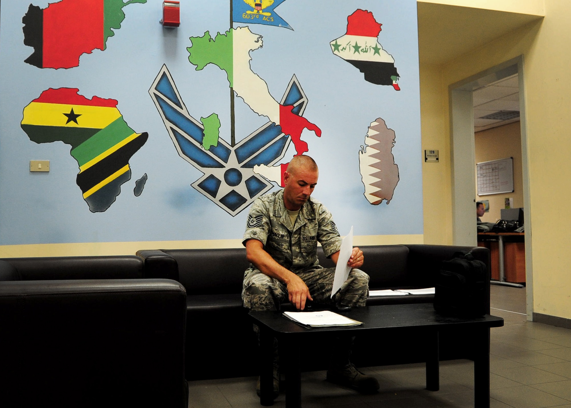 Tech. Sgt. Stephen Maclin, 603rd Air Control Squadron, prepares processing paperwork July 3 at Aviano Air Base, Italy.  The squadron provides air assets a clear mission picture through its command and control capability using tactical air operations modules.  (U.S. Air Force photo by Staff Sgt. Evelyn Chavez)