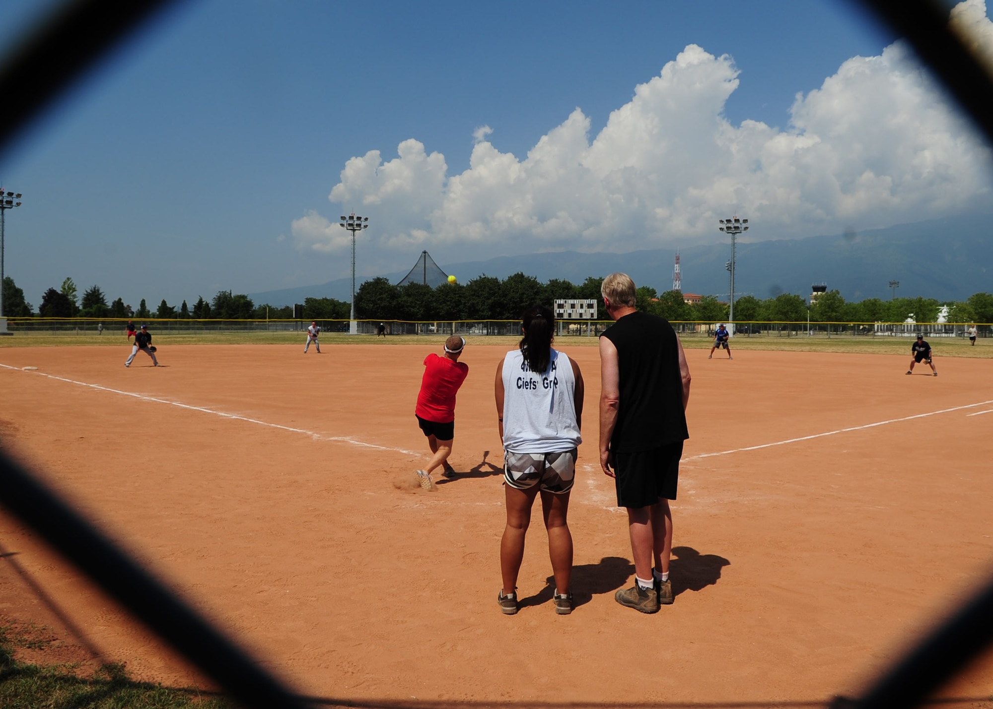 Players in the Chiefs versus Eagles game take the field July 4 at Aviano Air Base, Italy.  The game is a tradition held during base morale events in which chiefs, colonels, squadron commanders and other honorary participants challenge each other in sporting events.  The Chiefs were victorious over the Eagles with a final score of 21-12. (U.S. Air Force photo by Staff Sgt. Evelyn Chavez)