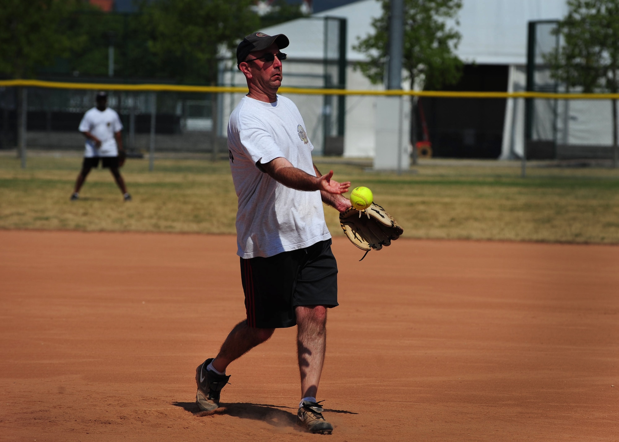 Chief Master Sgt. Jeffrey Craver, 31st Fighter Wing command chief, pitches a softball during the Chiefs versus Eagles game July 4 at Aviano Air Base, Italy.  The game is a tradition held during base morale events in which chiefs, colonels, squadron commanders and other honorary participants challenge each other in sporting events.  The Chiefs were victorious over the Eagles with a final score of 21-12. (U.S. Air Force photo by Staff Sgt. Evelyn Chavez)