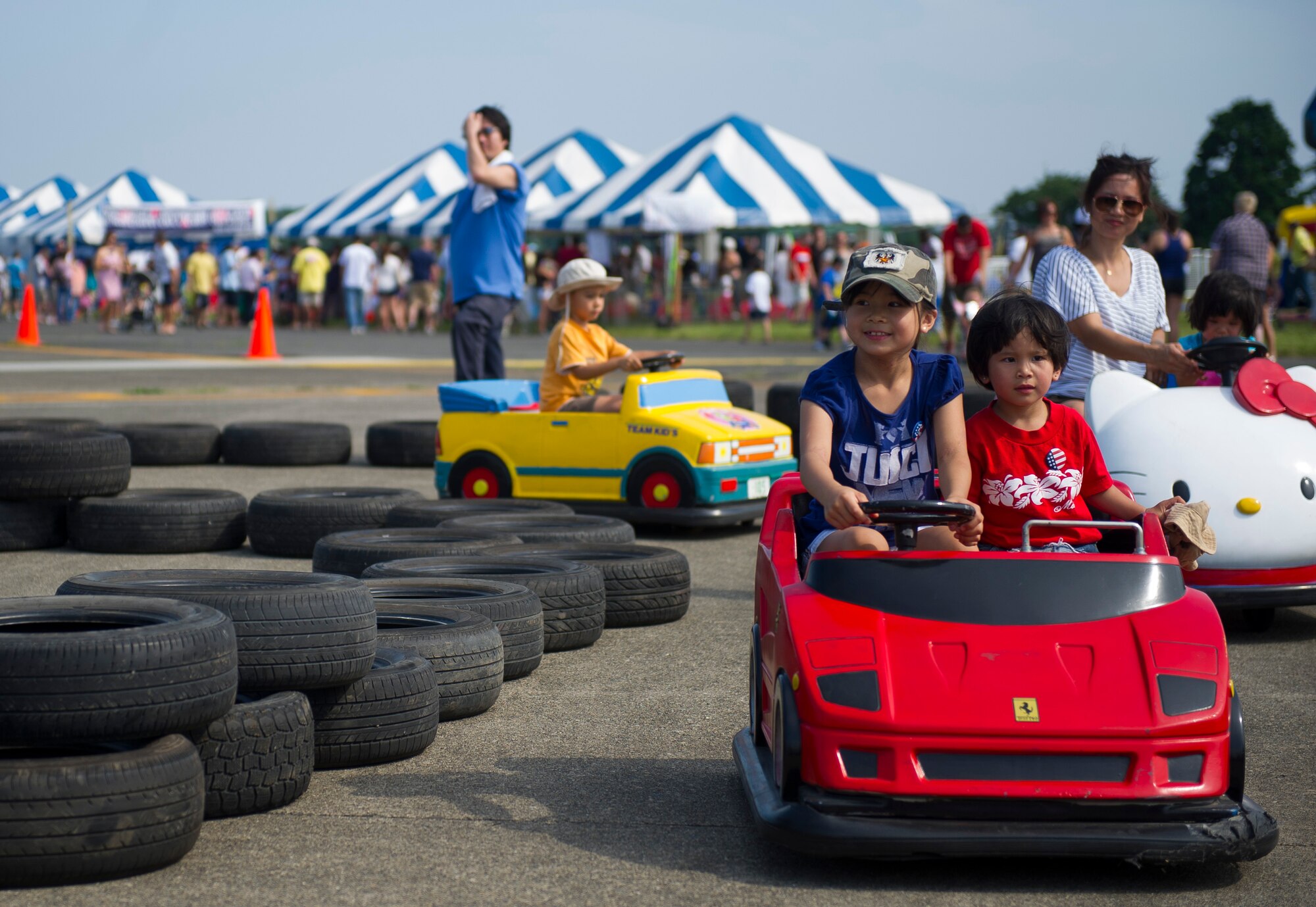 YOKOTA AIR BASE, Japan -- Children enjoy miniature go-carts at the Celebrate America event held July 4, 2012, at Yokota Air Base, Japan. The festivities also included face painting, carnival games, arts and crafts, and a fireworks show (U.S. Air Force photo by Staff Sgt. Chad C. Strohmeyer)
