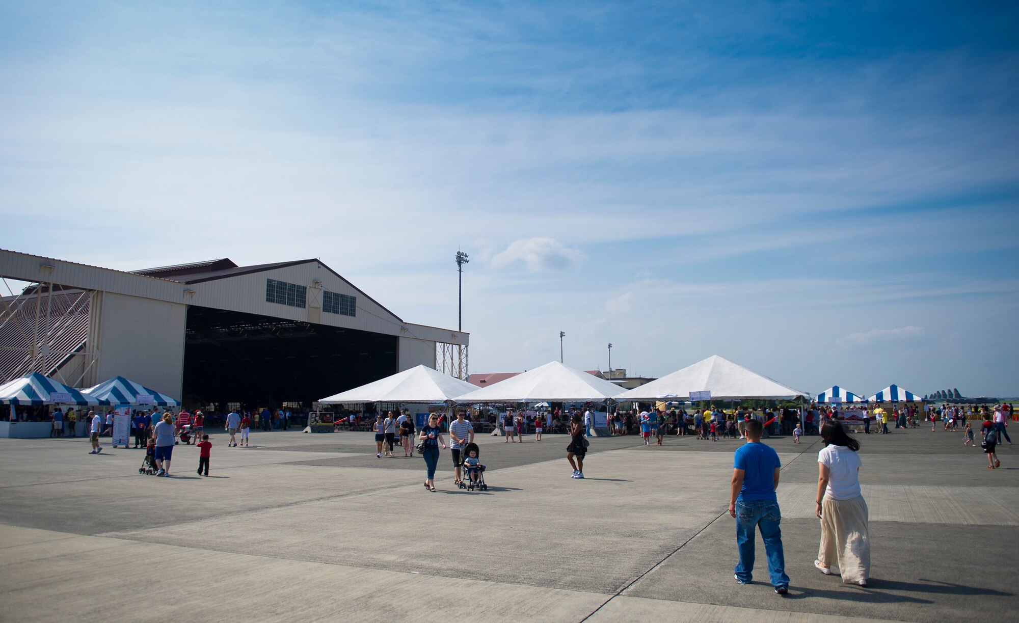 YOKOTA AIR BASE, Japan -- Attendees at the Celebrate America event held July 4, 2012, at Yokota Air Base, Japan, walk to different tents near Hangar 15. The festivities included go-carts, carnival games, bouncy castles and a petting zoo. (U.S. Air Force photo by Staff Sgt. Chad C. Strohmeyer)