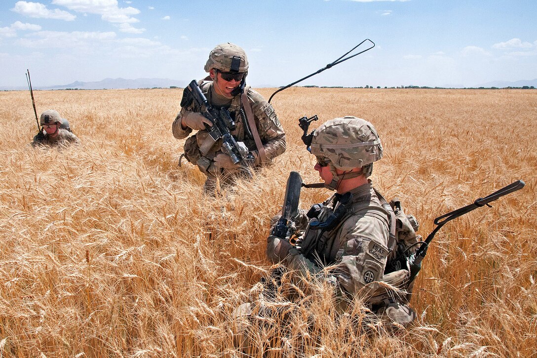 U.S. Army 2nd Lt. Nicholas Prieto, center, talks to U.S. Army Sgt. 1st Class Frank Downing, front, as the platoon manuevers on a position previously held by insurgents outside of Muqor in Afghanistan's Ghazni province, June 30, 2012. Prieto, a platoon leader, and Downing, a platoon sergeant, are assigned to the 82nd Airborne Division's 1st Battalion, 504th Parachute Infantry Regiment, 1st Brigade Combat Team.