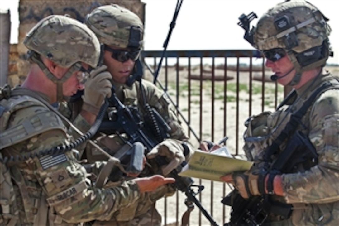 U.S. Army 2nd Lt. Nicholas Prieto, center, talks with U.S. Army Spc. Jonathan Myers, right, and U.S. Army Pfc. Blaze Glocar, left, as they call in air support during a firefight with insurgents in Afghanistan's Ghazni province, June 30, 2012. Prieto, a platoon leader, Myers, a forward observer, and Glocar, a radioman, are assigned to the 82nd Airborne Division's 1st Battalion, 504th Parachute Infantry Regiment, 1st Brigade Combat Team. 