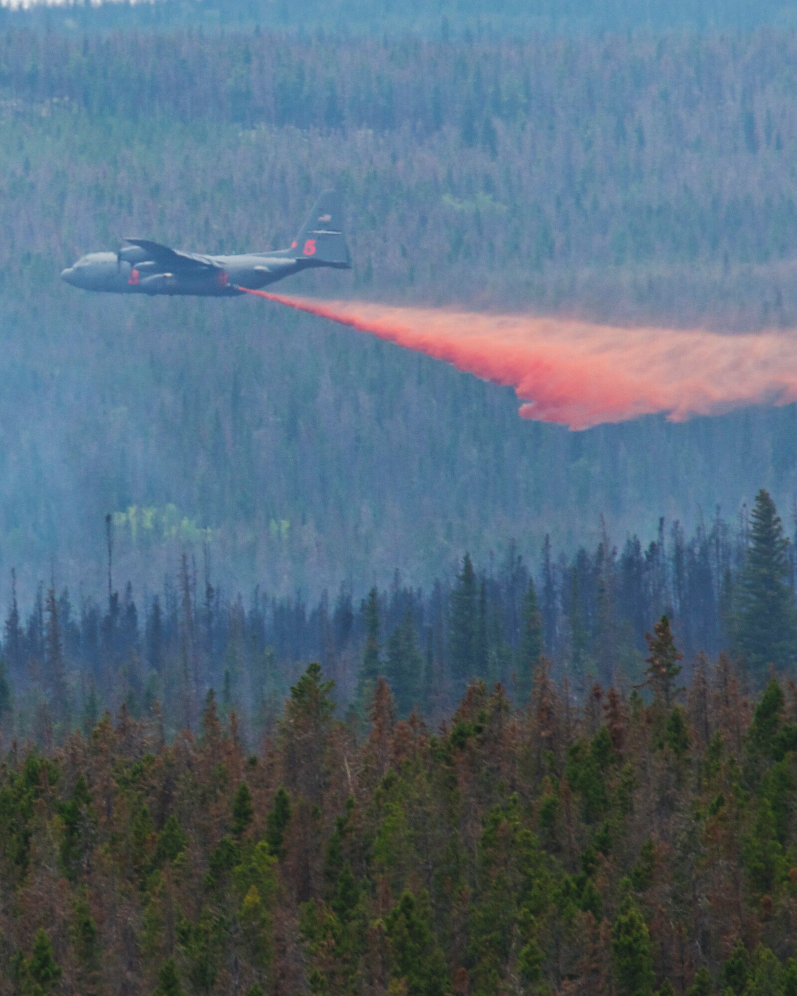 A C130-H equipped with Modular Airborne Firefighting Systems (MAFFS) from the 302nd Air Force Reserve Command in Colorado Springs, Colo. drops retardant near the Squirrel Creek fire about 70 miles east of Cheyenne. MAFFS is a self-contained aerial firefighting system owned by the U.S. Forest Service that can discharge 3,000 gallons of water or fire retardant in less than 5 seconds, covering an area one-quarter of a mile long by 100 feet wide. Once the load is discharged, it can be refilled in less than 12 minutes. (U.S. Air Force photo / Senior Airman Nicholas Carzis)
