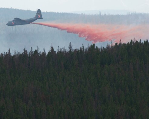 A C130-H equipped with Modular Airborne Firefighting Systems (MAFFS) from the 153rd Airlift Wing in Cheyenne, Wyo. drops retardant near the Squirrel Creek fire about 70 miles east of Cheyenne, July 6, 2012. MAFFS is a self-contained aerial firefighting system owned by the U.S. Forest Service that can discharge 3,000 gallons of water or fire retardant in less than 5 seconds, covering an area one-quarter of a mile long by 100 feet wide. Once the load is discharged, it can be refilled in less than 12 minutes. (U.S. Air Force photo / Senior Airman Nicholas Carzis)
