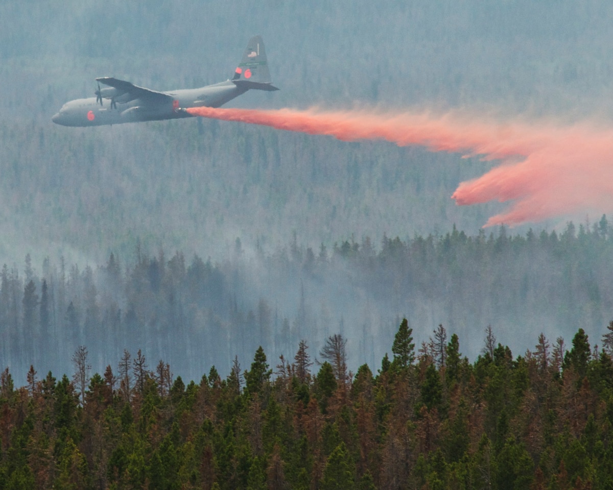 A C130-J equipped with Modular Airborne Firefighting Systems (MAFFS) from the 146th Airlift Wing in Port Hueneme, Calif. drops retardant near the Squirrel Creek fire about 70 miles east of Cheyenne July 6, 2012. MAFFS is a self-contained aerial firefighting system owned by the U.S. Forest Service that can discharge 3,000 gallons of water or fire retardant in less than 5 seconds, covering an area one-quarter of a mile long by 100 feet wide. Once the load is discharged, it can be refilled in less than 12 minutes. (U.S. Air Force photo / Senior Airman Nicholas Carzis)