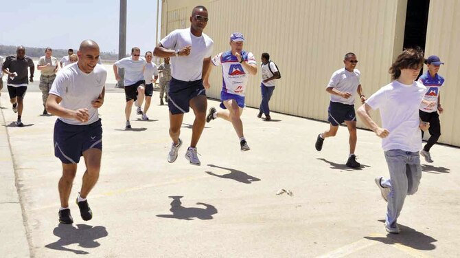 452 Air Mobility Wing members practice a running drill, where runners lunge into the air as they run; it’s one of many drills taught to help increase an individual’s ability to run more efficiently, during the second running clinic hosted by March FITT, inside and outside Hangar 452, June 23. The first running clinic, held last June was such a success, Ian Adamson, director of research and education, Newton Running, was invited back to continue to help Airmen improve their running techniques and extend their running life. (U.S. Air Force photo by/ Staff Sgt. Megan Crusher)