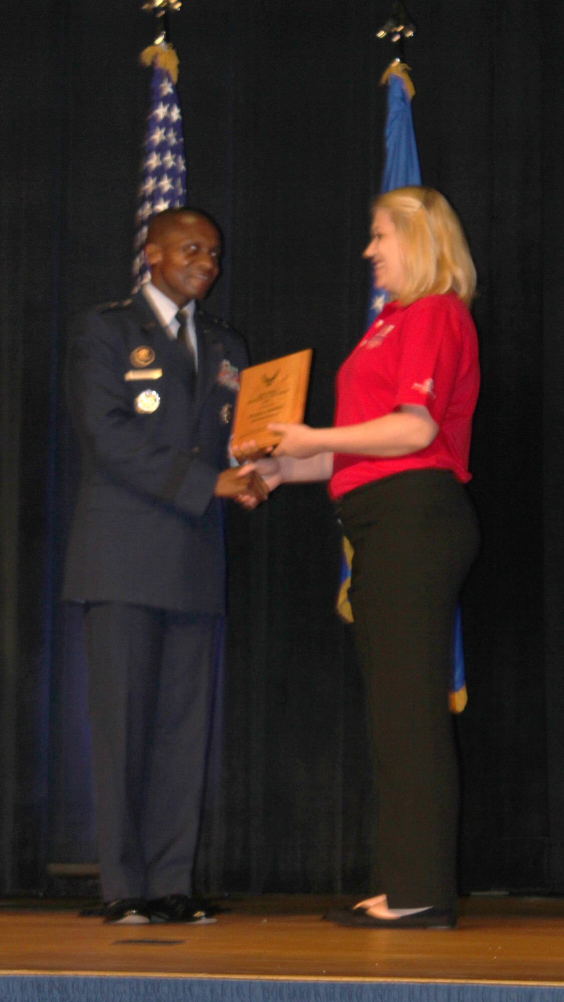 PENTAGON, Washington D.C. – Natasha Johnson receives a plaque from Maj. Gen. Darren McDew, Air Force District of Washington commander, at the Air Force Youth of the Year awards ceremony June 21, 2012, at the Pentagon. Johnson won the RAF Mildenhall Youth of the Year award and placed second at U.S. Air Forces in Europe. All winners and runners-up of the Boys and Girls Club of America awards throughout Europe and the United States were given the opportunity to travel to Washington D.C. to receive their plaques. (Courtesy photo by Kari Rosett)