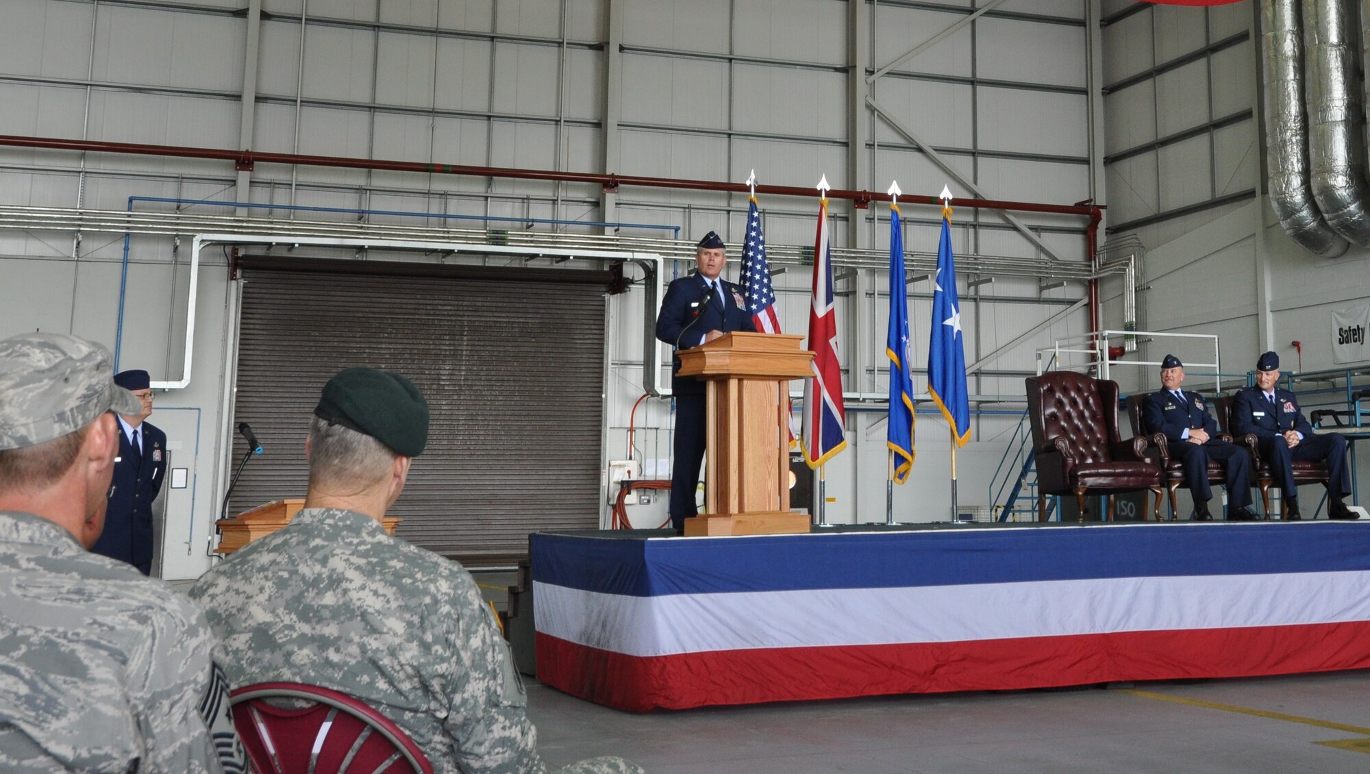 Lt. Gen. Eric E. Fiel, Air Force Special Operations Command commander, commends Col. Gary McCollum for his service as 352nd Special Operations Group commander during a change of command ceremony at RAF Mildenhall, England, in Hangar 814 July 6, 2012. McCollum relinquished command to Col. Christopher Ireland during the event which was officiated by Fiel. (U.S. Air Force photo/Staff Sgt. Thomas Trower)