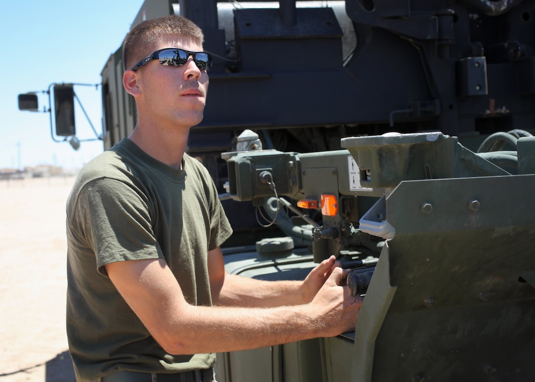 Pfc. Tim M. Byers, a motor transport mechanic with 9th Communication Battalion, operates levers on a vehicle during Large Scale Exercise 1, Javelin Thrust 2012, July 6, 2012. Javelin Thrust is an annual large-scale exercise at Marine Corps Air Ground Combat Center Twentynine Palms, Calif., which allows active and reserve Marines and sailors from 38 different states to train together as a seamless Marine Air Ground Task Force.