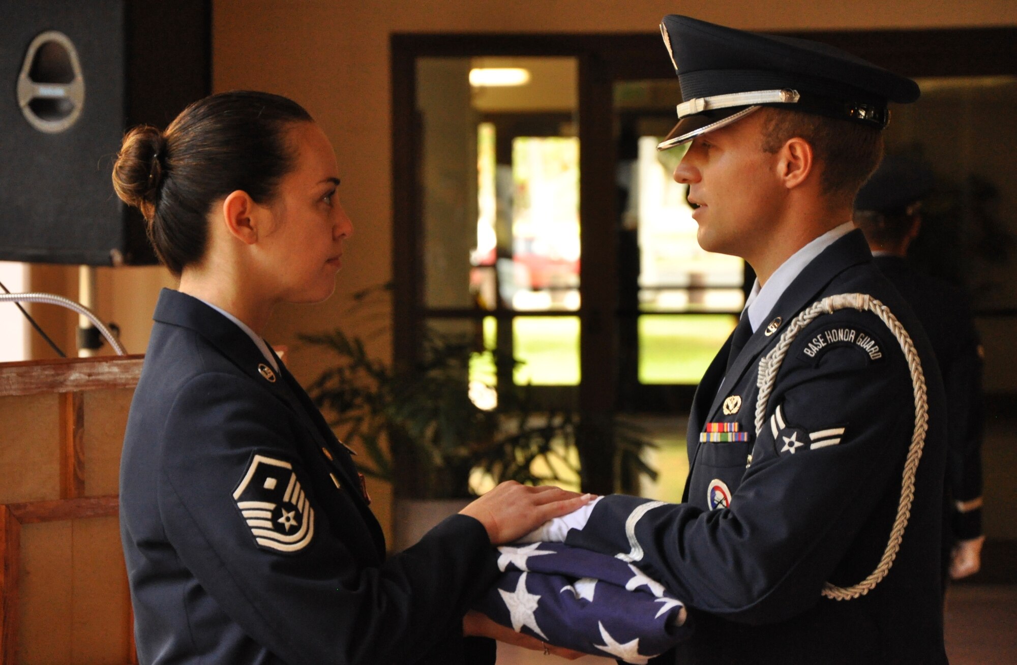 JOINT BASE PEARL HARBOR-HICKAM, Hawaii -- A base honor guardsman presents Master Sgt. Tammy Thompson a flag at a retirement ceremony held in her honor July 7, 2012, at the Courtyard of Heroes at the Headquarters, Pacific Air Forces building here. Sergeant Thompson retires from the Air Force Reserve after twenty-four years of service. She began her career as a C-5 Galaxy Crew chief in 1988. In February 1995, she cross-trained to become a structural craftsman with the 704th Civil Engineer Squadron here, the present 624th CES. After a few years stint with the 477th CES, Elmendorf, Alaska, she returned to her home with the 624th CES to serve as a First Sergeant. She supported Operation Iraqi Freedom and was chosen as PACAF’s Outstanding First Sergeant of the Year in the Reserve category. (Air Force photo by Master Sgt. Daniel Nathaniel)