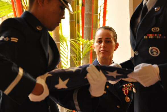 JOINT BASE PEARL HARBOR-HICKAM, Hawaii -- Master Sgt. Tammy Thompson watches as the base honor guard folds a flag at a retirement ceremony held in her honor July 7, 2012, at the Courtyard of Heroes at the Headquarters, Pacific Air Forces building here. Sergeant Thompson retires from the Air Force Reserve after twenty-four years of service. She began her career as a C-5 Galaxy Crew chief in 1988. In February 1995, she cross-trained to become a structural craftsman with the 704th Civil Engineer Squadron here, the present 624th CES. After a few years stint with the 477th CES, Elmendorf, Alaska, she returned to her home with the 624th CES to serve as a First Sergeant. She supported Operation Iraqi Freedom and was chosen as PACAF’s Outstanding First Sergeant of the Year in the Reserve category. (Air Force photo by Master Sgt. Daniel Nathaniel)