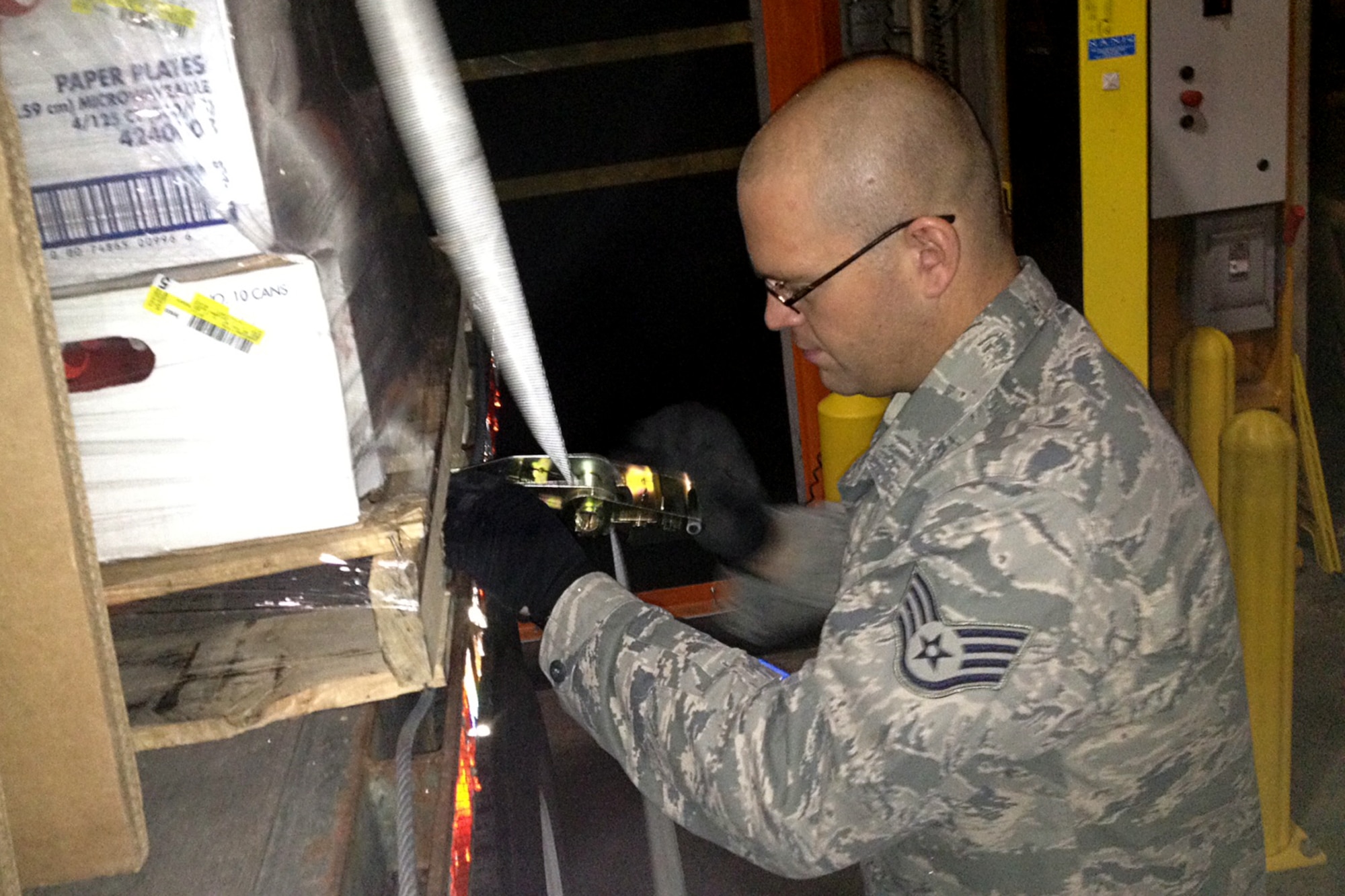 GRISSOM AIR RESERVE BASE, Ind. -- Staff Sgt. David Lapprad, 49th Aerial Port Flight apprentice, ties down cargo to a flat bed during a recent annual tour training trip to Joint Base Elmendorf--Richardson, Alaska.  (U.S. Air Force photo/Tech. Sgt. Bradley Frank)
