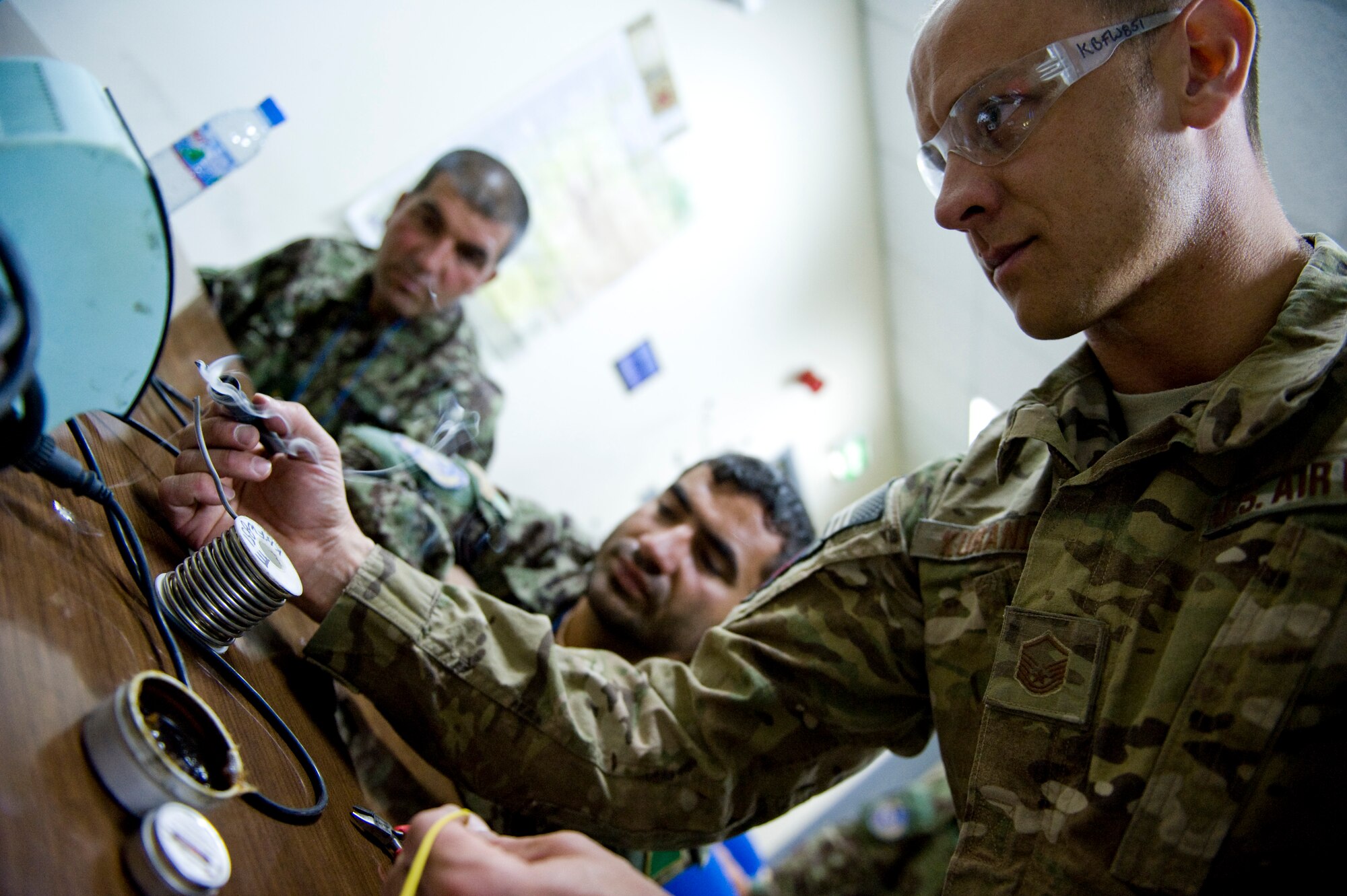U.S. Air Force Master Sgt. Jamie Kuranda, a C-27A maintenance advisor with the 440th Air Expeditionary Advisory Squadron, demonstrates soldering techniques to Afghan air force Electrical and Radio C-27A maintainers different types of wire crimps, in Kabul, Afghanistan on July 7, 2012. The mission of the 440th AEAS is to train, mentor and advise Afghan air force Kabul Air Wing members capable of sustaining a healthy fleet that is ready to perform training and operational missions in support of Afghan national security requirements today and in the future. (U.S. Air Force photo by Staff Sgt. Greg C. Biondo)(Released)