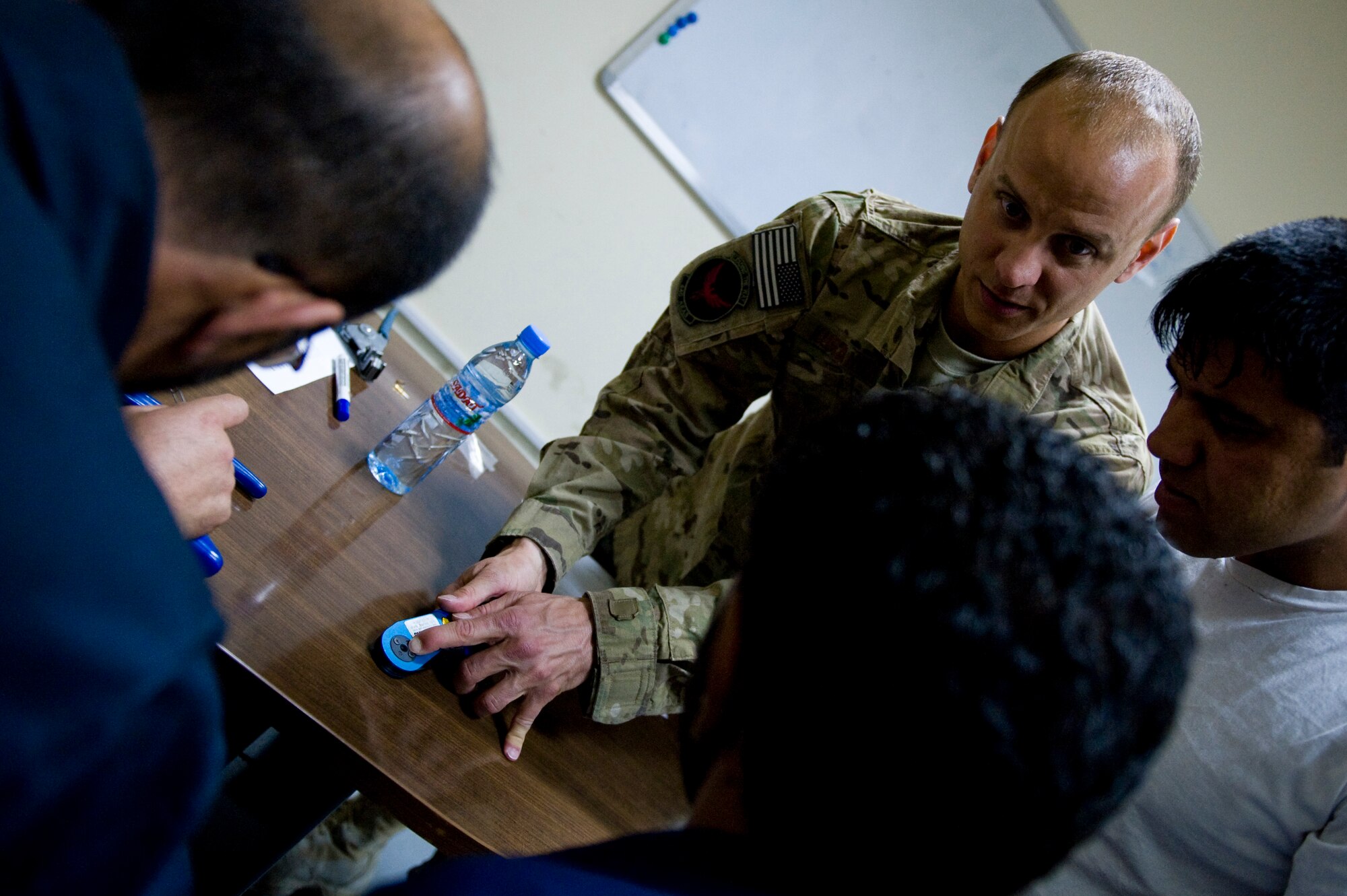 U.S. Air Force Master Sgt. Jamie Kuranda, a C-27A maintenance advisor with the 440th Air Expeditionary Advisory Squadron, shows Afghan air force Electrical and Radio C-27A maintainers the proper way to use a wire crimper, in Kabul, Afghanistan on July 7, 2012. The mission of the 440th AEAS is to train, mentor and advise Afghan air force Kabul Air Wing members capable of sustaining a healthy fleet that is ready to perform training and operational missions in support of Afghan national security requirements today and in the future. (U.S. Air Force photo by Staff Sgt. Greg C. Biondo)(Released)
