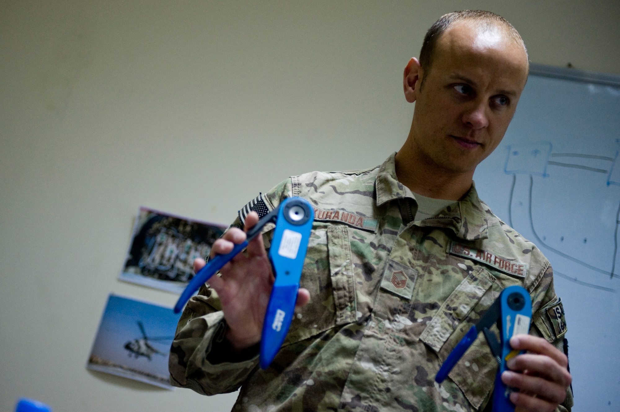 U.S. Air Force Master Sgt. Jamie Kuranda, 440th Air Expeditionary Advisory Squadron C-27A maintenance advisor, shows Afghan air force Electrical and Radio C-27A maintainers different types of wire crimps during a four-day class July 7, 2012 at Kabul International Airport, Afghanistan. The mission of the 440th AEAS is to train, mentor and advise Afghan air force Kabul Air Wing members capable of sustaining a healthy fleet that is ready to perform training and operational missions in support of Afghan national security requirements today and in the future. (U.S. Air Force photo by Staff Sgt. Greg C. Biondo)(Released)