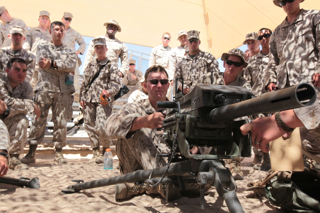 MARINE CORPS AIR GROUND COMBAT CENTER TWENTYNINE PALMS, Calif. - Marines from 1st Marine Expeditionary Brigade, Law Enforcement Battalion receive a class on the MK19 grenade launcher. This class is being given to remediate the Marines prior to live-fire weapons training during Javelin Thrust 2012. Javelin Thrust is an annual large-scale exercise which allows active and reserve Marines and Sailors from 38 different states to train together as a seamless Marine Air Ground Task Force. (Photo by Sgt. Kevin M. Okamura/Released)