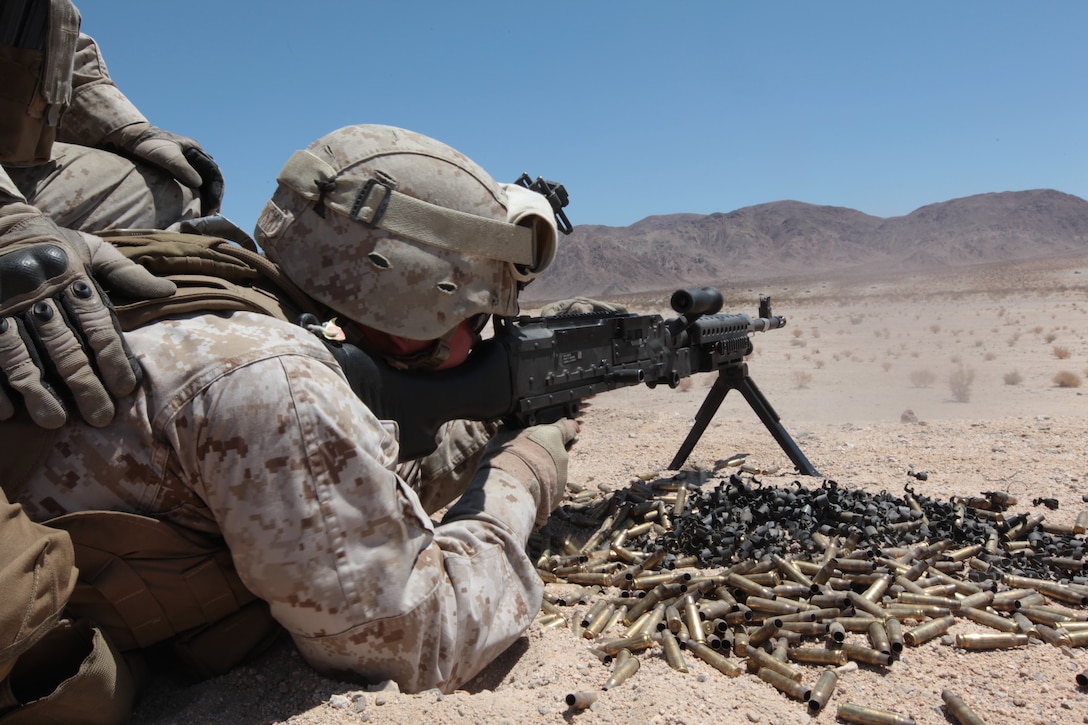 MARINE CORPS AIR GROUND COMBAT CENTER TWENTYNINE PALMS, Calif. - A Marine from 1st Marine Expeditionary Brigade, Law Enforcement Battalion fires the M240G machine gun during Javelin Thrust 2012. Javelin Thrust is an annual large scale exercise which allows active and reserve Marines and Sailors from 38 different states to train together as a seamless Marine Air Ground Task Force. (Photo by Sgt. Kevin M. Okamura/Released)