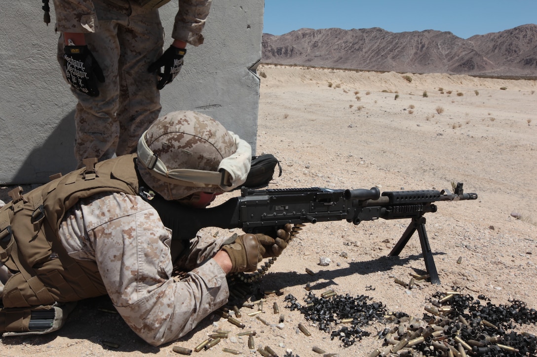 MARINE CORPS AIR GROUND COMBAT CENTER TWENTYNINE PALMS, Calif. - Marines from 1st Marine Expeditionary Brigade, Law Enforcement Battalion fires the M240G machine gun during Javelin Thrust 2012.  Javelin Thrust 2012 is an annual large scale exercise which allows active and reserve Marines and Sailors from 38 different states to train together as a seamless Marine Air Ground Task Force. (Photo by Sgt. Kevin M. Okamura/Released)