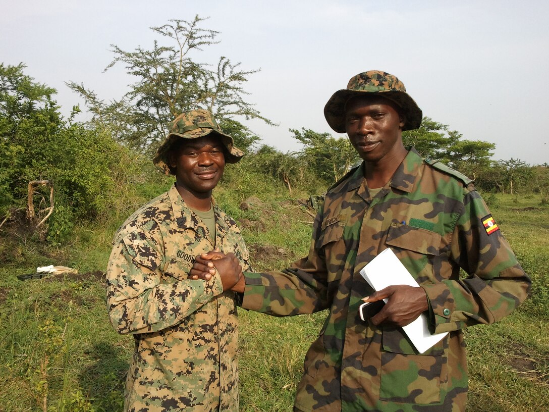 MSgt. Anthony Goodwater, left, a Charleston, S.C., native and combat engineer with Battalion Landing Team, 1st Battalion, 2nd Marine Regiment, 24th Marine Expeditionary Unit, poses for a photo with 1st Lt. Martin Orech, of the Ugandan Army, during a training mission in Uganda, June 15, 2012.  Goodwater previously trained Orech at the Marine Corps' Combat Engineer Officer Course in 2010 and was reunited with Orech unexpectedly when he was sent to Uganda to assist in training Ugandan soldiers.