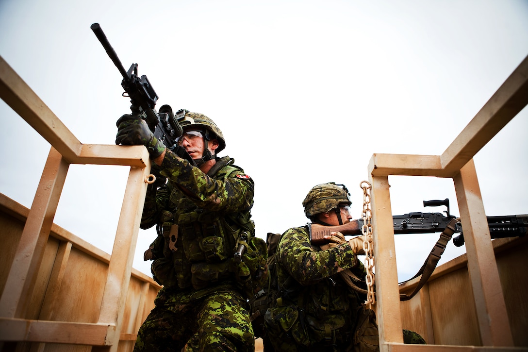 Pvt. Shilo Francis-Arduh, a platoon signaler with Company A, 2nd Battalion, Princess Patricia's Canadian Light Infantry, provides security while his fireteam clears a bridge during a Military Operations on Urban Terrain exercise at Marine Corps Training Area Bellows on July, 6. Approximately 2,200 personnel from nine nations are participating in RIMPAC 2012 as part of Special Purpose Marine Air-Ground Task Force 3, Combined Force Land Component Command. The CFLCC is conducting amphibious and land-based operations in order to enhance multinational and joint interoperability. Twenty-two nations, more than 40 ships and submarines, more than 200 aircraft and 25,000 personnel are participating in RIMPAC exercise from June 29 to Aug. 3, in and around the Hawaiian Islands. The world's largest international maritime exercise, RIMPAC provides a unique training opportunity that helps participants foster and sustain the cooperative relationships that are critical to ensuring the safety of sea lanes and security on the world's oceans. RIMPAC 2012 is the 23rd exercise in the series that began in 1971.