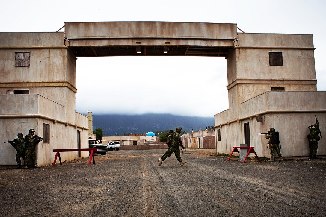 Soldiers from Company A, 2nd Battalion, Princess Patricia's Canadian Light Infantry, move past a danger area during a Military Operations on Urban Terrain exercise at Marine Corps Training Area Bellows on July, 6. Approximately 2,200 personnel from nine nations are participating in RIMPAC 2012 as part of Special Purpose Marine Air-Ground Task Force 3, Combined Force Land Component Command. The CFLCC is conducting amphibious and land-based operations in order to enhance multinational and joint interoperability. Twenty-two nations, more than 40 ships and submarines, more than 200 aircraft and 25,000 personnel are participating in RIMPAC exercise from June 29 to Aug. 3, in and around the Hawaiian Islands. The world's largest international maritime exercise, RIMPAC provides a unique training opportunity that helps participants foster and sustain the cooperative relationships that are critical to ensuring the safety of sea lanes and security on the world's oceans. RIMPAC 2012 is the 23rd exercise in the series that began in 1971.