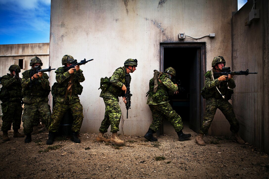 Soldiers from Company A, 2nd Battalion, Princess Patricia's Canadian Light Infantry, move to clear a house during a Military Operations on Urban Terrain exercise at Marine Corps Training Area Bellows on July, 6. Approximately 2,200 personnel from nine nations are participating in RIMPAC 2012 as part of Special Purpose Marine Air-Ground Task Force 3, Combined Force Land Component Command. The CFLCC is conducting amphibious and land-based operations in order to enhance multinational and joint interoperability. Twenty-two nations, more than 40 ships and submarines, more than 200 aircraft and 25,000 personnel are participating in RIMPAC exercise from June 29 to Aug. 3, in and around the Hawaiian Islands. The world's largest international maritime exercise, RIMPAC provides a unique training opportunity that helps participants foster and sustain the cooperative relationships that are critical to ensuring the safety of sea lanes and security on the world's oceans. RIMPAC 2012 is the 23rd exercise in the series that began in 1971.