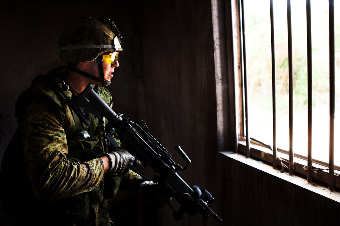 A soldier from Company A, 2nd Battalion, Princess Patricia's Canadian Light Infantry, provides security while clearing a house during a Military Operations on Urban Terrain exercise at Marine Corps Training Area Bellows on July, 6. Approximately 2,200 personnel from nine nations are participating in RIMPAC 2012 as part of Special Purpose Marine Air-Ground Task Force 3, Combined Force Land Component Command. The CFLCC is conducting amphibious and land-based operations in order to enhance multinational and joint interoperability. Twenty-two nations, more than 40 ships and submarines, more than 200 aircraft and 25,000 personnel are participating in RIMPAC exercise from June 29 to Aug. 3, in and around the Hawaiian Islands. The world's largest international maritime exercise, RIMPAC provides a unique training opportunity that helps participants foster and sustain the cooperative relationships that are critical to ensuring the safety of sea lanes and security on the world's oceans. RIMPAC 2012 is the 23rd exercise in the series that began in 1971.