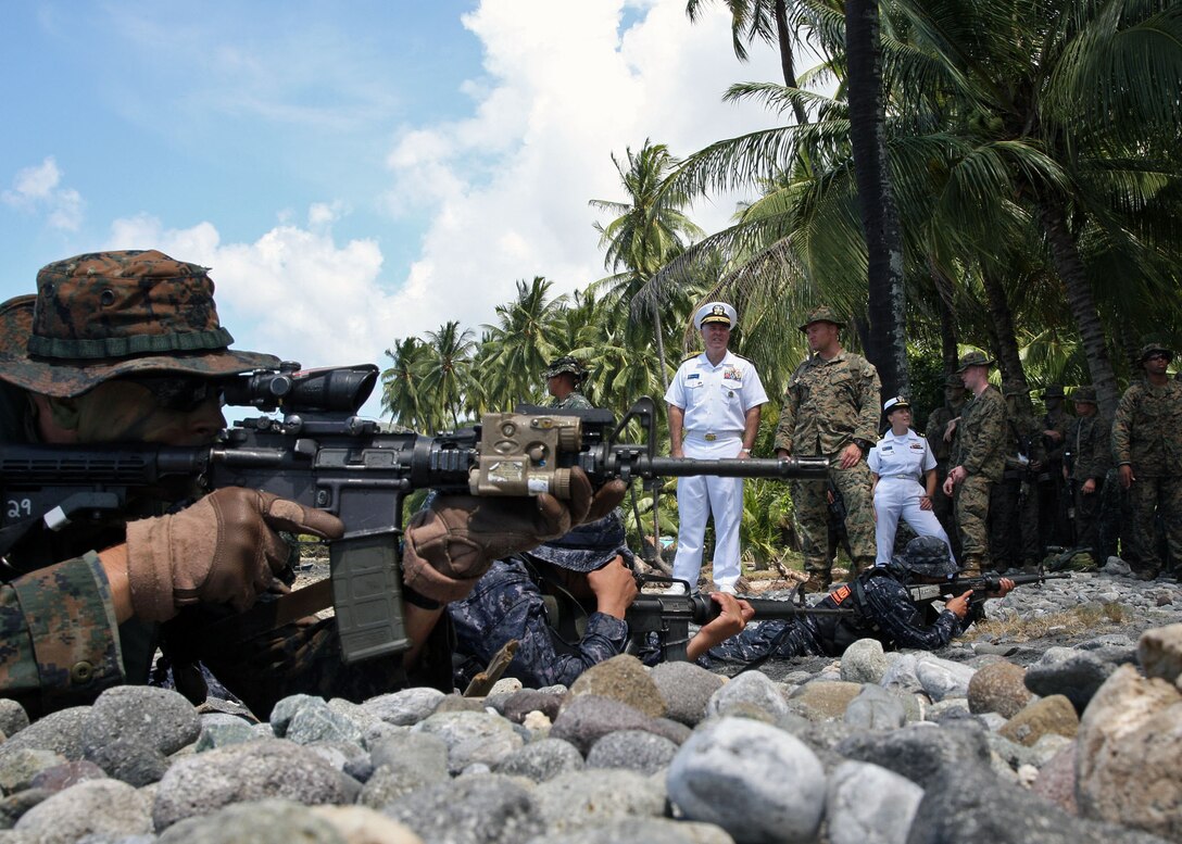Rear Adm. Thomas Carney commander, Task Force 73, observes U.S. Marines, assigned to Fleet Anti-terrorism Security Team Pacific, and Philippine Marines and Coast Guardsman conduct an amphibious beach assault exercise during Cooperation Afloat Readiness and Training (CARAT) Philippines 2012. CARAT is a series of bilateral military exercises between the U.S. Navy and the armed forces of Bangladesh, Brunei, Cambodia, Indonesia, Malaysia, the Philippines, Singapore, and Thailand. Timor Leste joins the exercise for the first time in 2012.
