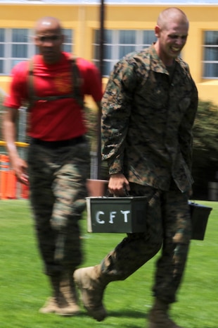 A recruit of Comapany A, 1st Recruit Training Battalion, carries two ammunition-cans as he sprints through the manuever under fire portion during the Combat Fitness Test aboard Marine Corps Recruit Depot San Diego June 21. The manuever under fire is the last portion of the CFT. The CFT is an annual requirement for Marines that tests their combat readiness. Recruits must complete and pass the CFT to move forward with recruit training.