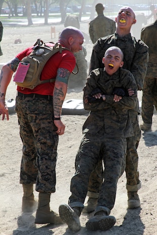 Staff Sgt. Brian Reza, drill instructor, Company B, 1st Recruit Training Battalion, challenges recruits' volume as they war cry from one exercise to another during the Combat Conditioning Exercise aboard Marine Corps Recruit Depot San Diego June 27. Drill instructors motivated recruits during the CCX, pushing them past their limitations, testing them both mentally and physically.