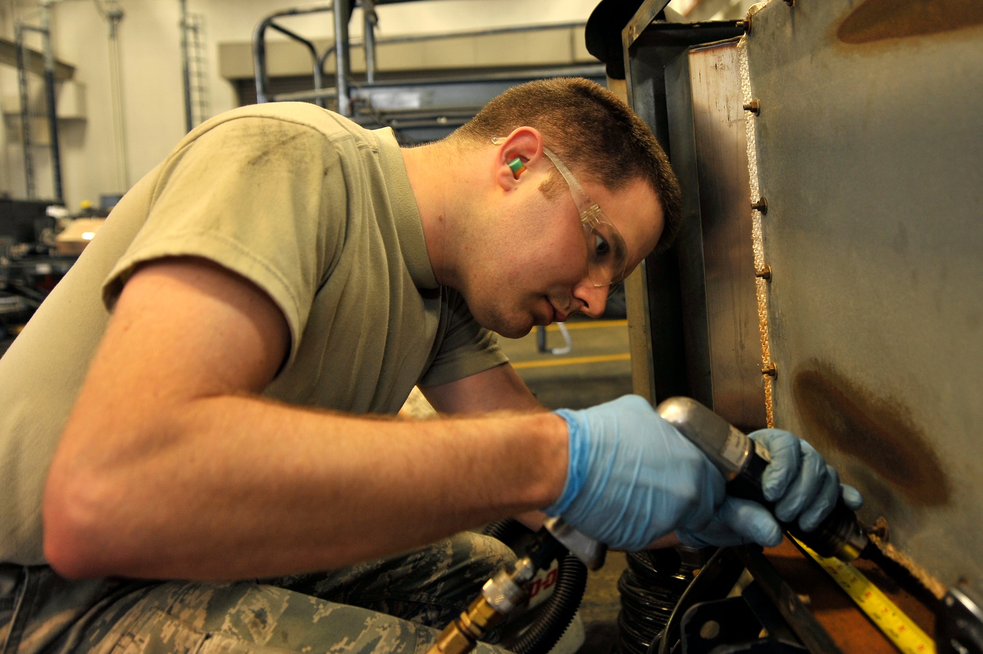 U.S. Air Force Airman 1st Class Christopher Jones, 35th Maintenance Squadron aerospace ground equipment journeyman, drills holes to allow water to drain from a new generation heater at Misawa Air Base, Japan, July 9, 2012. By creating drains in areas of the heater that collect water, Jones is able to prevent corrosion from damaging the equipment. (U.S. Air Force photo by Staff Sgt. Nathan Lipscomb/Released) 