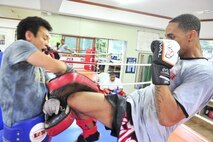 Senior Airman James Turner, 51st Maintenance Group aircraft metal technology journeyman, practices kneeing while sparring with Grand Master Myong Chae Kim, June 18, 2012. Kim has 30 years of experience and has trained more than 500 airmen, five of whom have competed at national level. (U.S. Air Force photo/Senior Airman Adam Grant)
