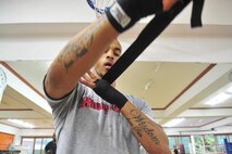 Senior Airman James Turner, 51st Maintenance Group aircraft metal technology journeyman, wraps his wrist before sparring June 18, 2012. Muay Thai kickboxing is a combative sport from Thailand that uses stand-up striking along with various clinching techniques similar to other Indochinese kickboxing systems. (U.S. Air Force photo/Senior Airman Adam Grant)

