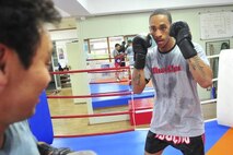 Senior Airman James Turner, 51st Maintenance Group aircraft metal technology journeyman, prepares to punch during a sparring session with Grand Master Myong Chae Kim, June 18, 2012. Kim has 30 years of experience and has trained more than 500 airmen, five of whom have competed at national level. (U.S. Air Force photo/Senior Airman Adam Grant)

