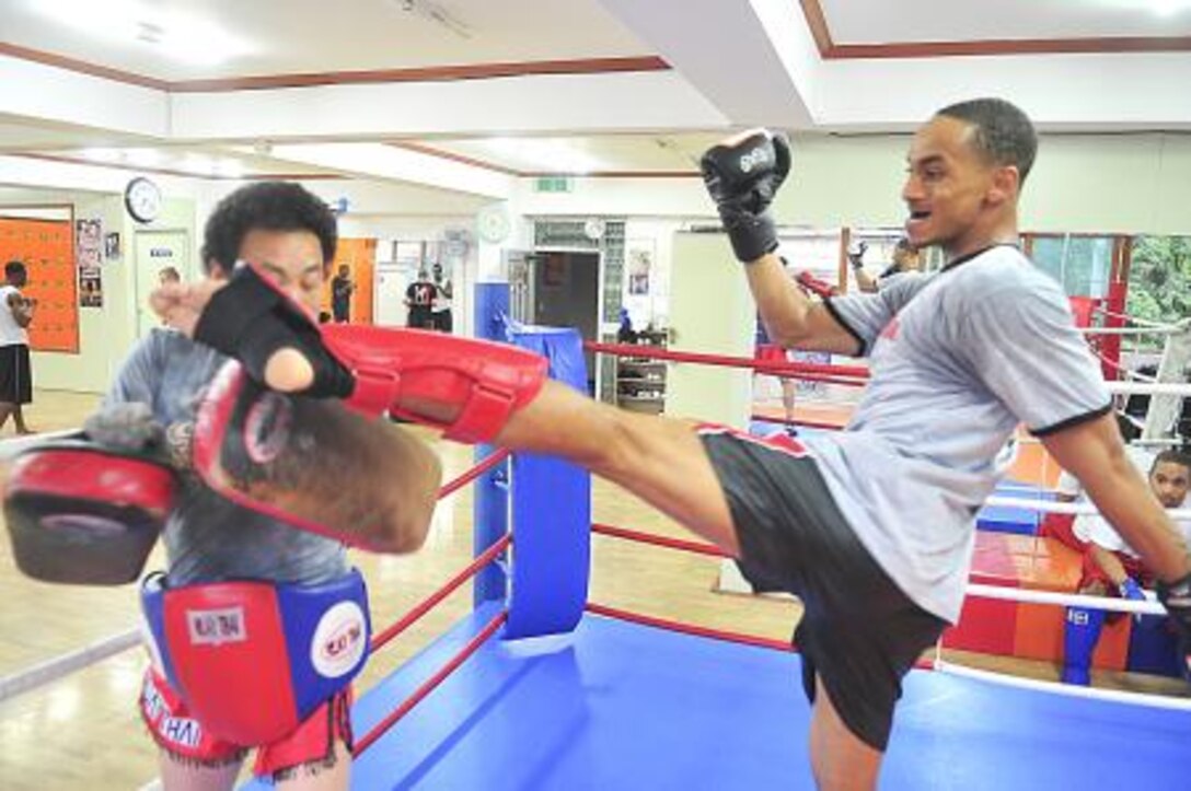 Senior Airman James Turner, 51st Maintenance Group aircraft metal technology journeyman, kicks Grand Master Myong Chae Kim, during a sparring session with June 18, 2012. Turner is currently at in intermediate level, still honing his skills and perfecting his craft with the intent of someday competing professionally in a grand prix tournament. (U.S. Air Force photo/Senior Airman Adam Grant)
