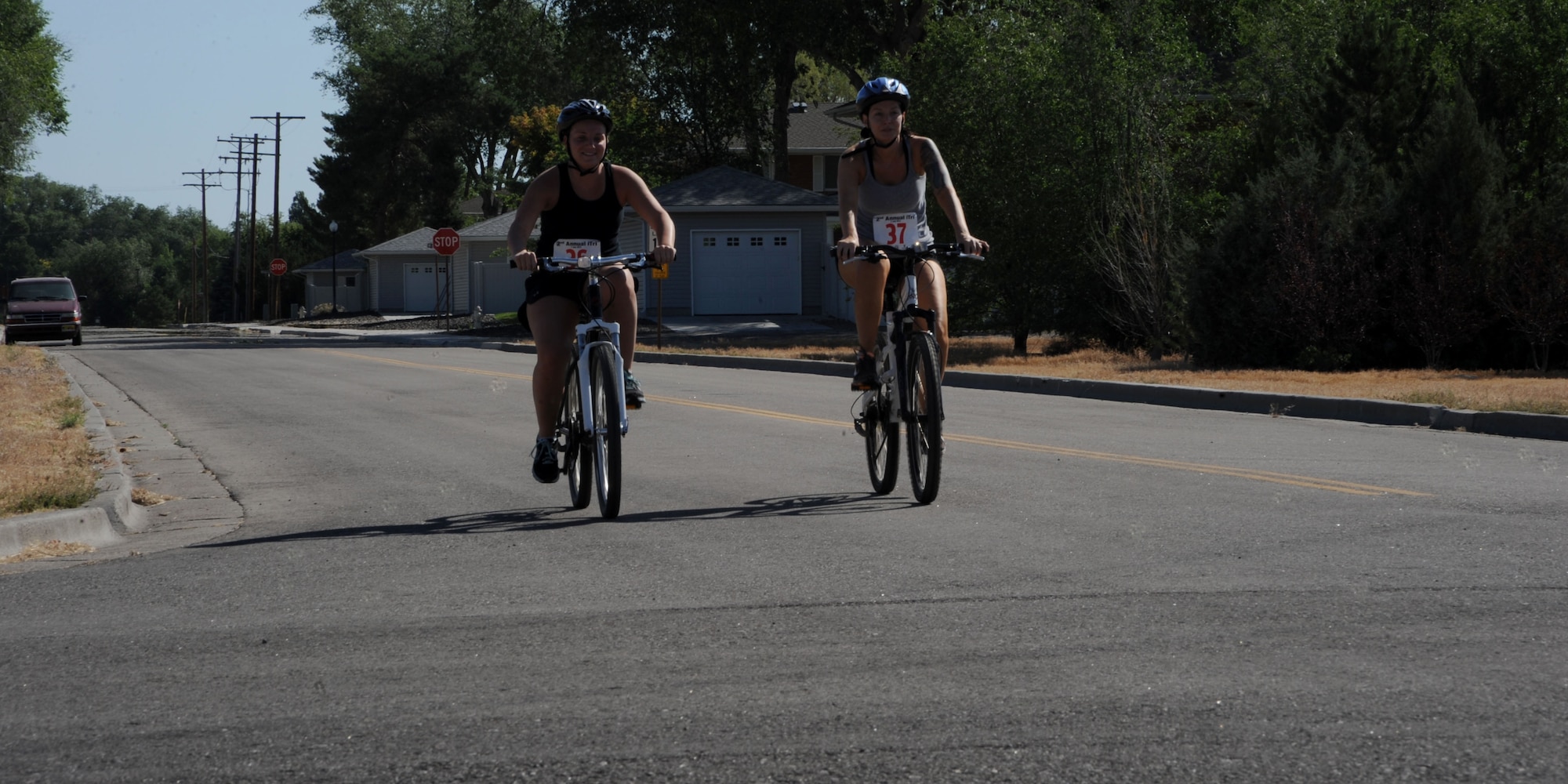 Erin Metcalf and Brooke Pouliotte ride side-by-side during the second annual triathlon July 7 at Mountain Home Air Force Base, Idaho. More than 35 Gunfighters participated in the event hosted by the base fitness center. (U.S. Air Force photo/Senior Airman Benjamin Sutton) 